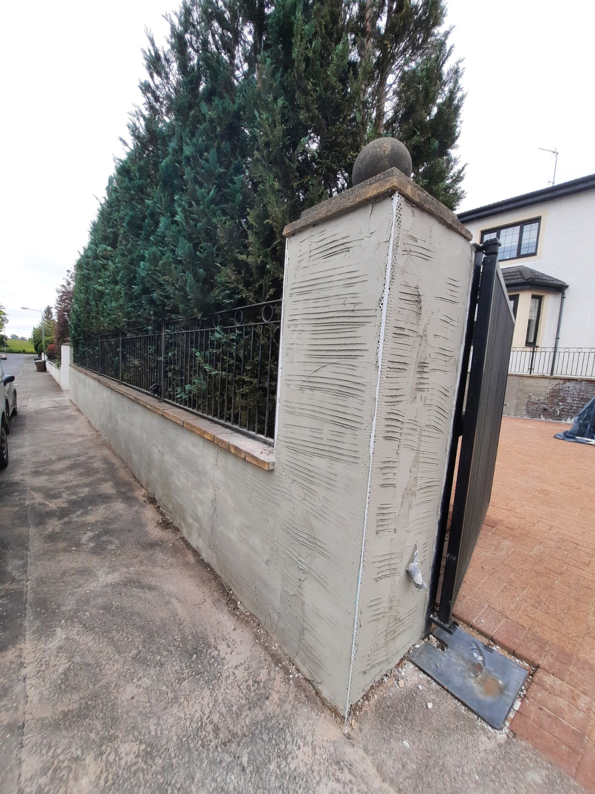 Insulation Edinburgh beneath fresh base coat on boundary wall