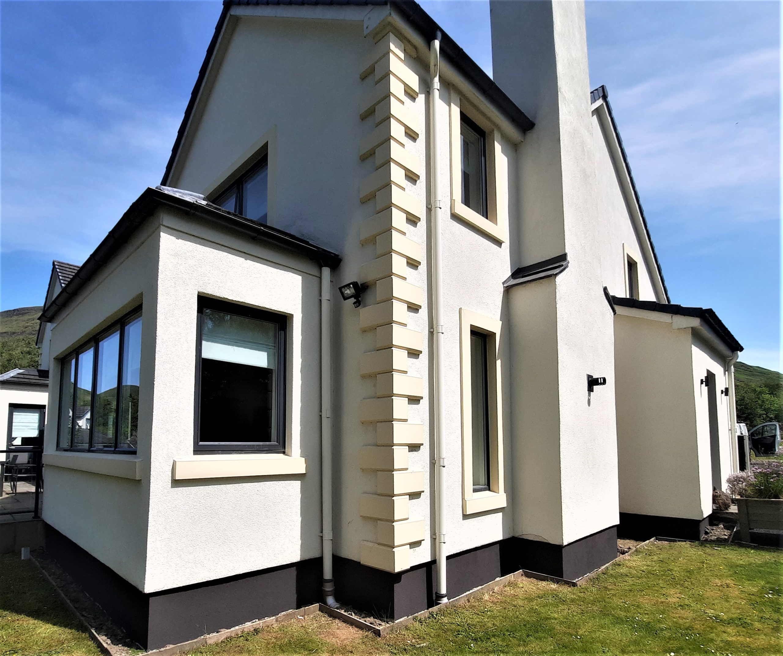 roughcasting Edinburgh on white house with black trim and tall chimney