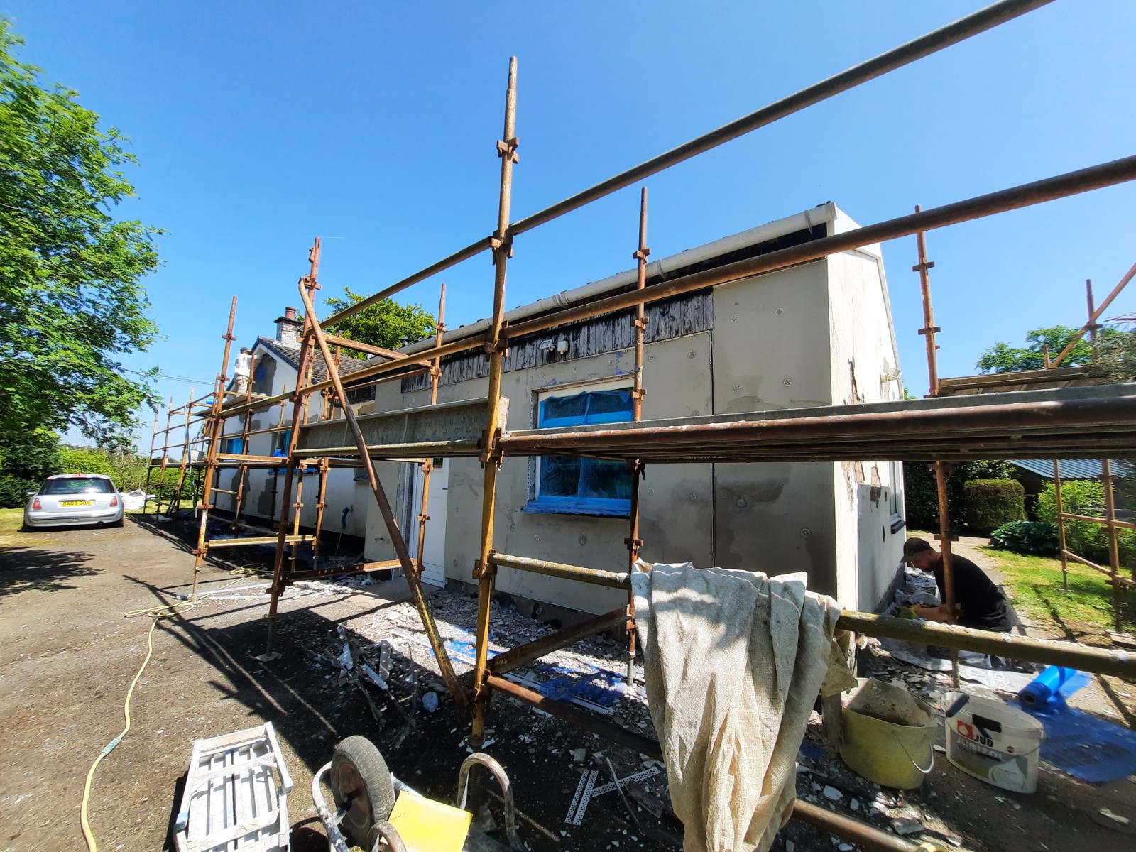 roughcast render repair on side elevation with scaffolding