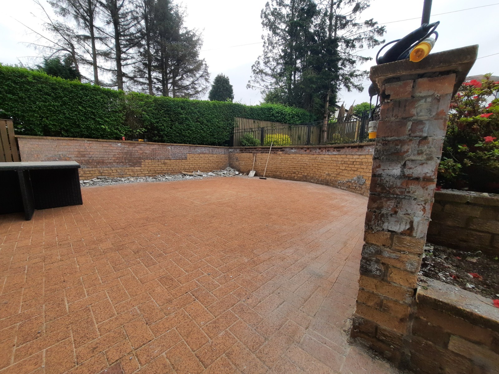 roughcast repair in progress on paved driveway area