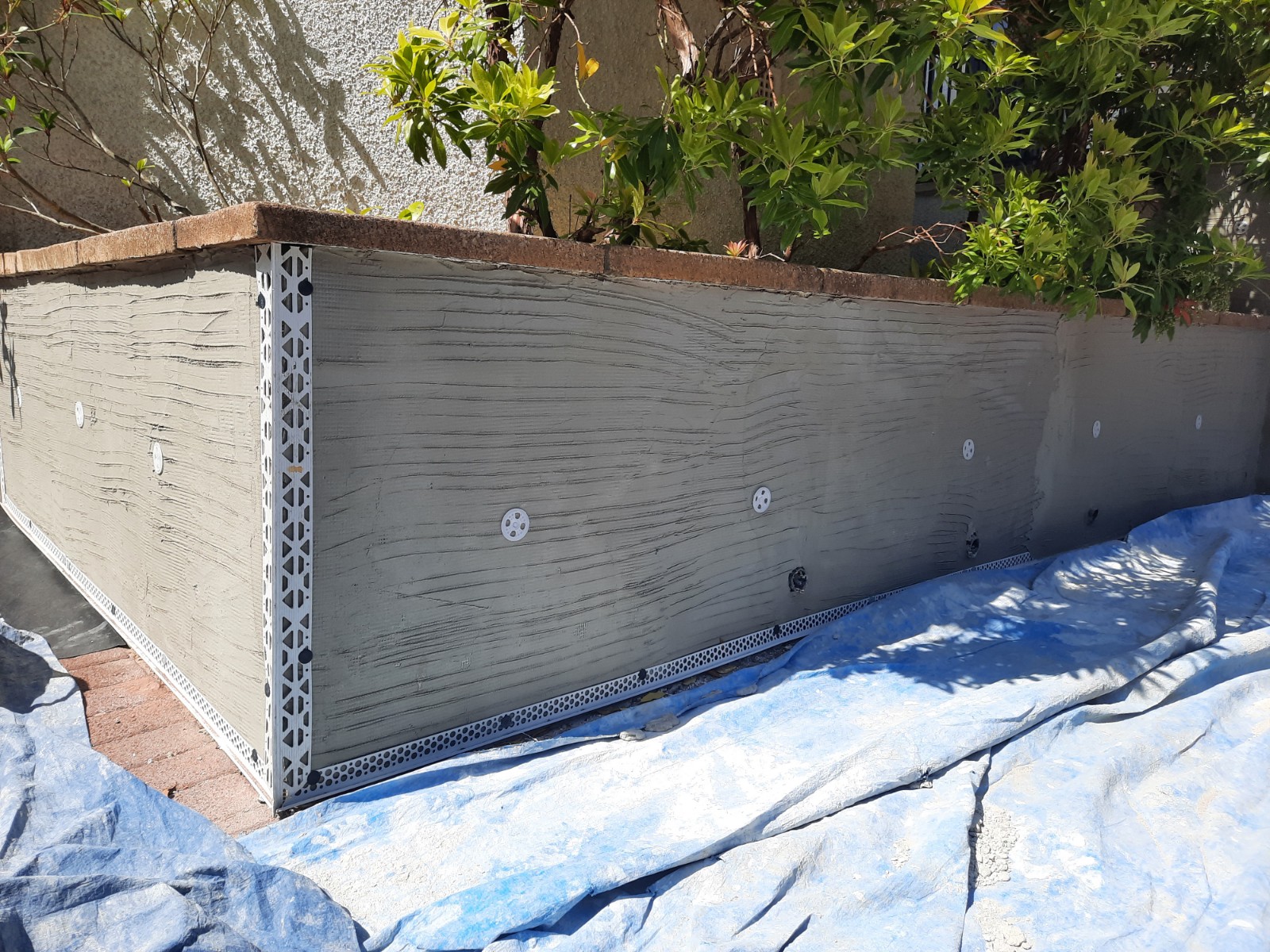 house rendering Edinburgh on smooth wall section before finishing coat