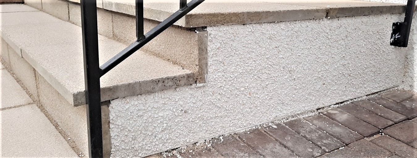 Insulation Edinburgh beneath clean white render along driveway wall