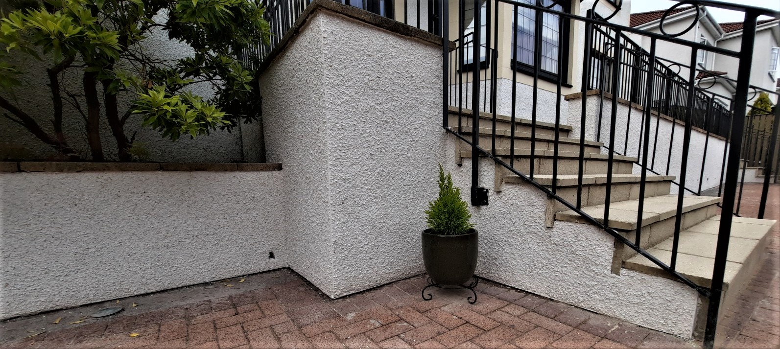 Rendering Edinburgh on corner boundary wall beside steps