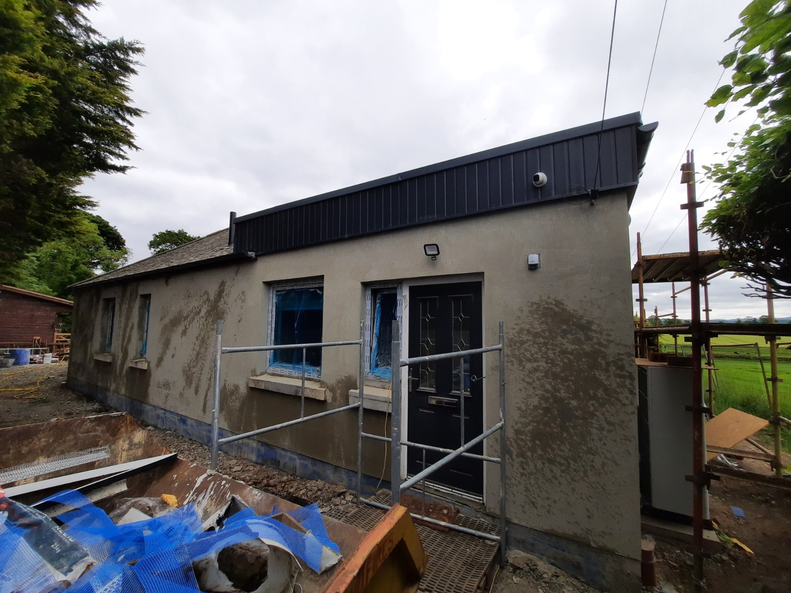 roughcast repair on home with fresh base render coat