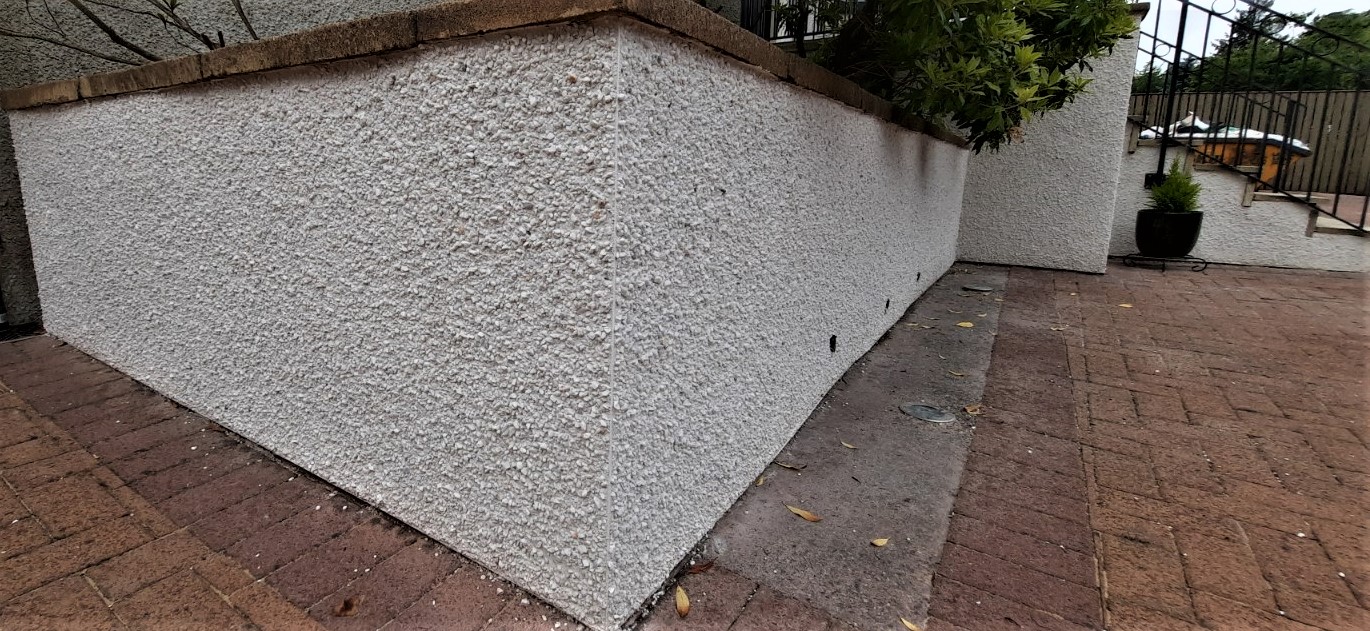 roughcast repair on boundary wall with coping stones