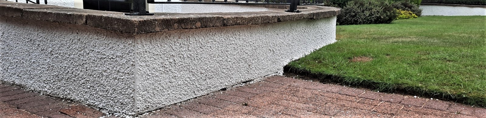 Insulation Edinburgh beneath textured render on garden wall