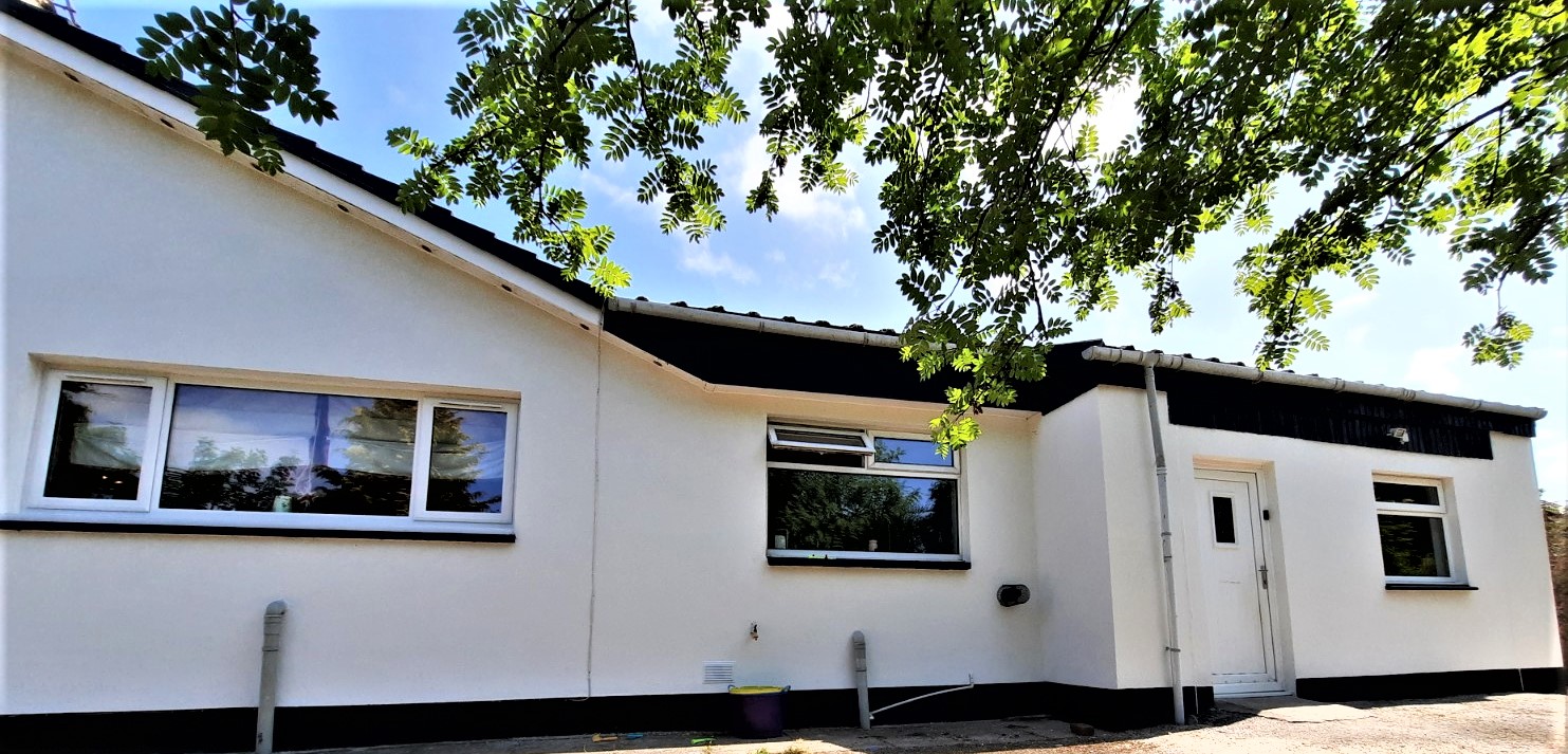 roughcaster Edinburgh finishing front-facing wall with window and black trim