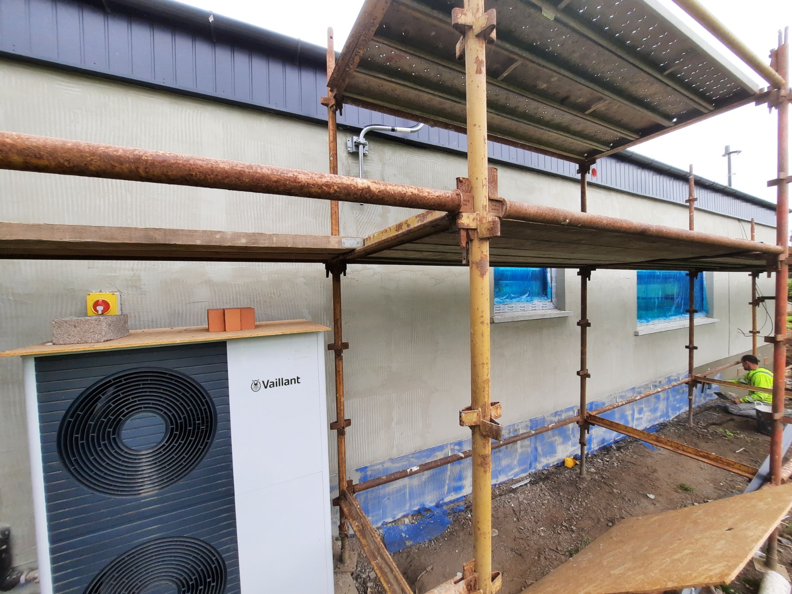 roughcaster Edinburgh working on rear wall under wooden scaffolding