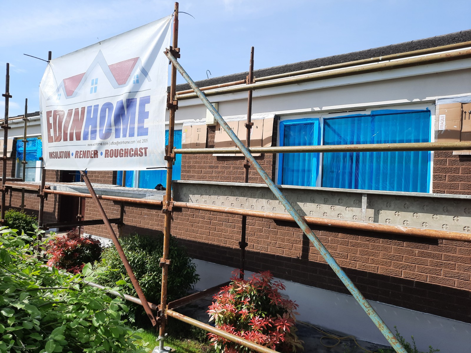 roughcast repair on rear wall under scaffold and blue sheeting