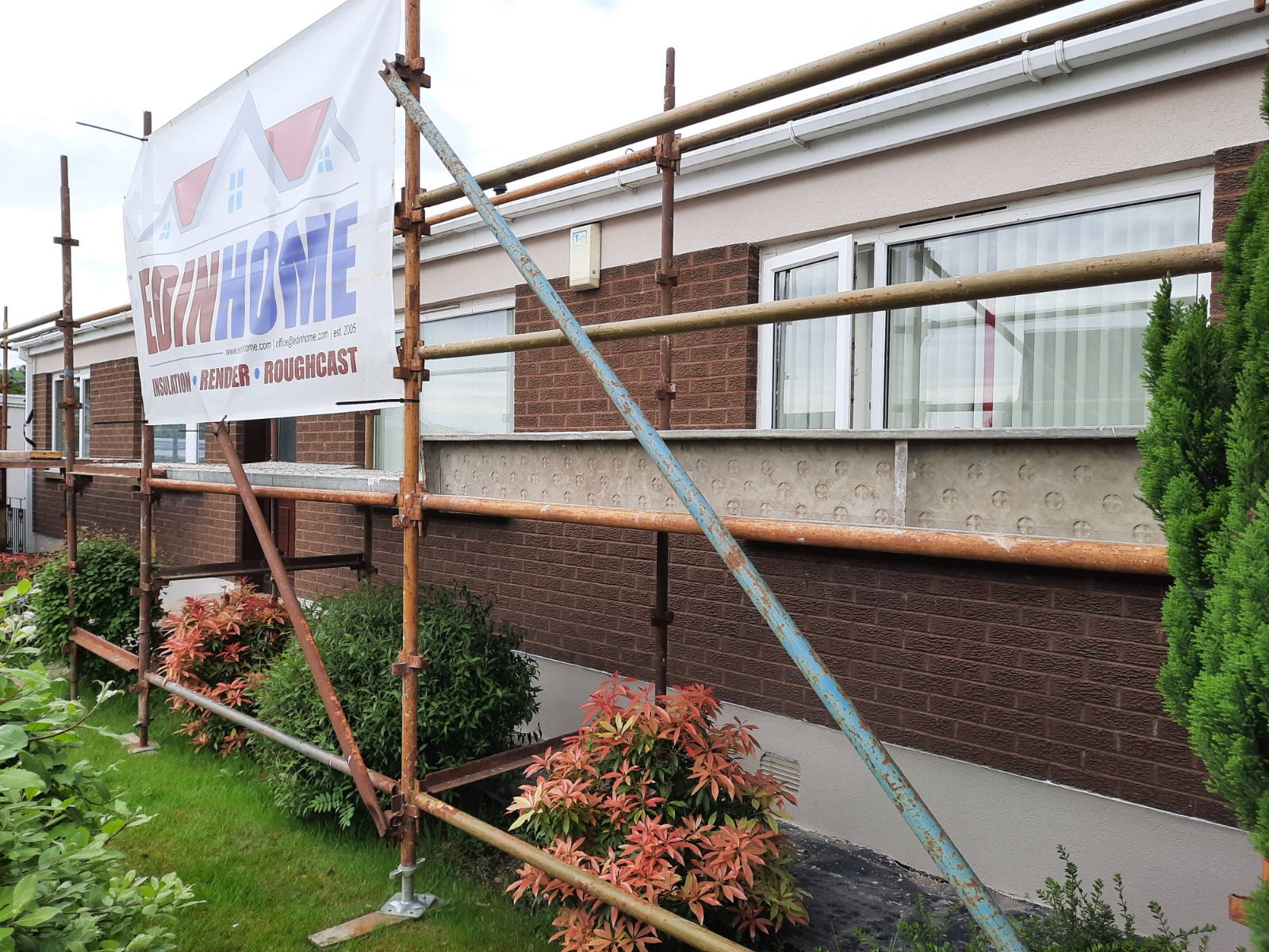 roughcast render Edinburgh on brick and render rear wall under scaffolding