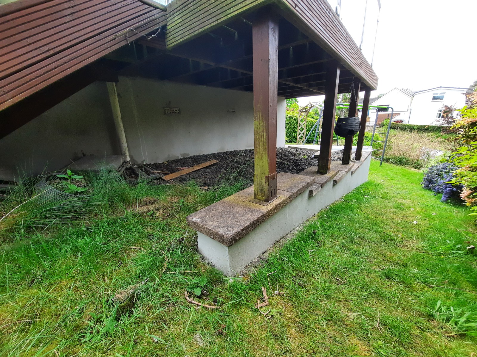 roughcast render repair beneath covered decking area