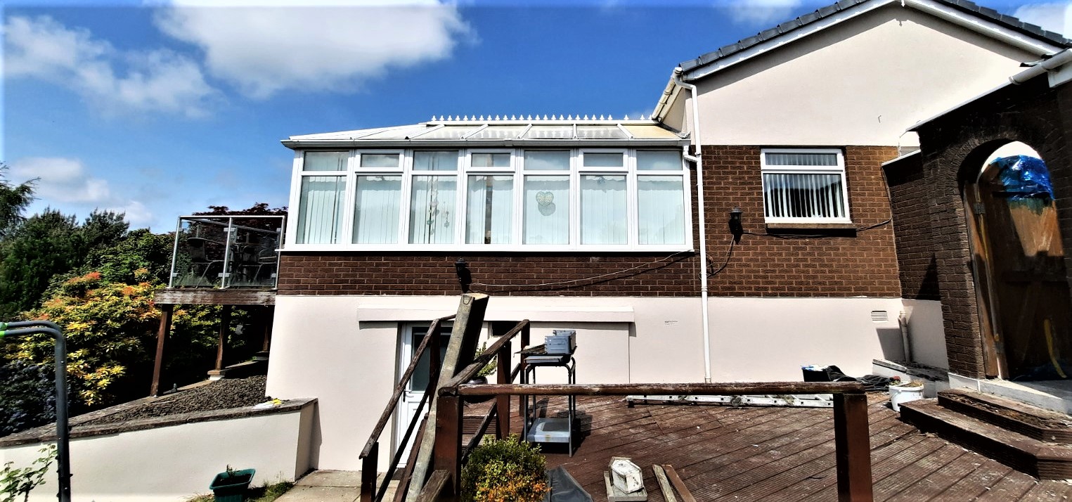 roughcast render repair along back wall beneath conservatory windows