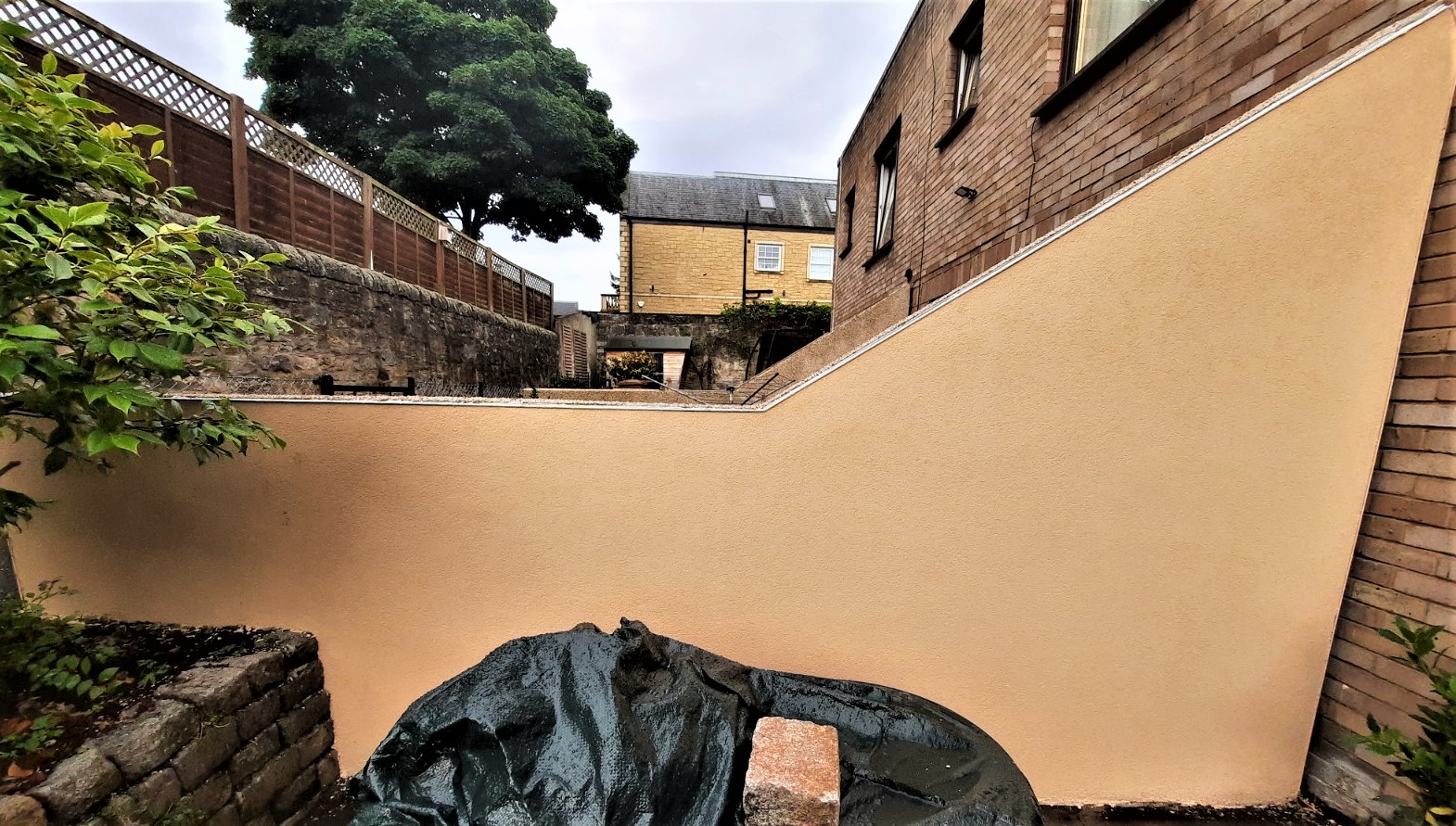 roughcast render Edinburgh on smooth beige boundary wall