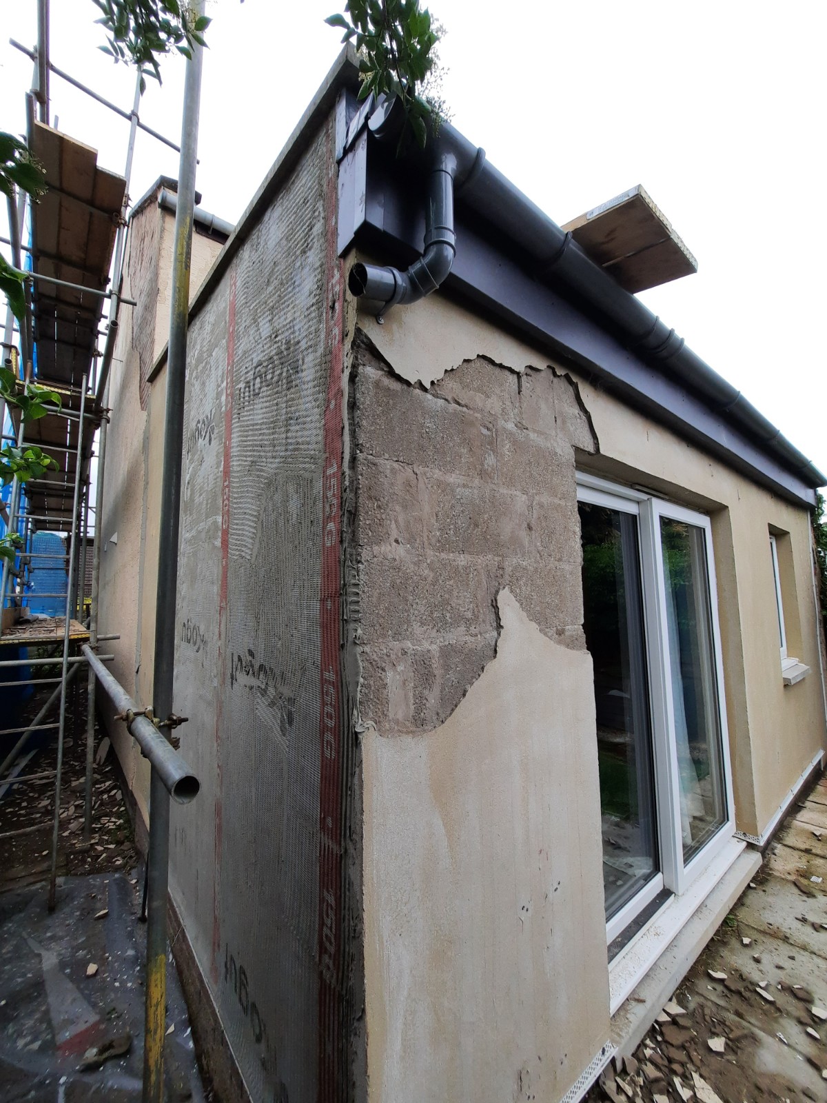 house rendering Edinburgh under renovation with scaffold