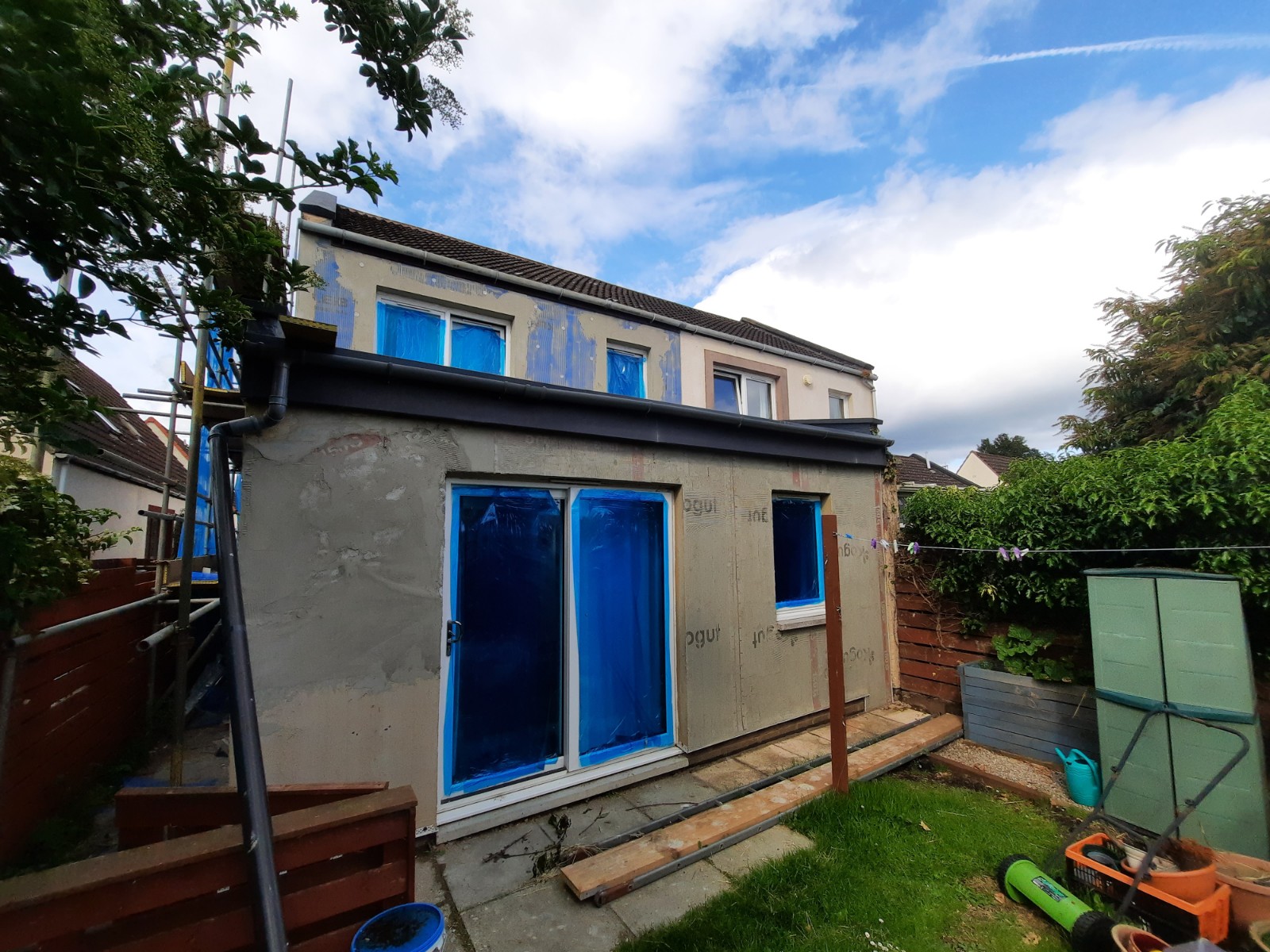 roughcaster Edinburgh working on side wall with new render layer
