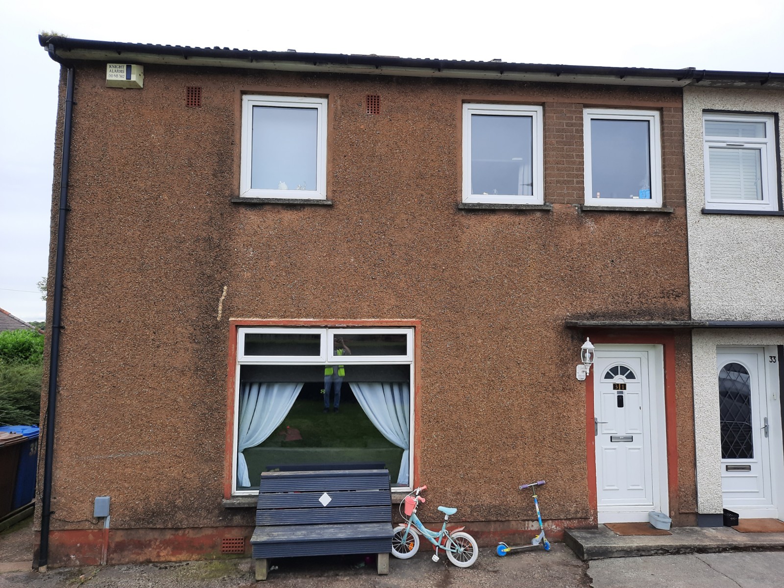 roughcast render repair planned for front elevation with white door