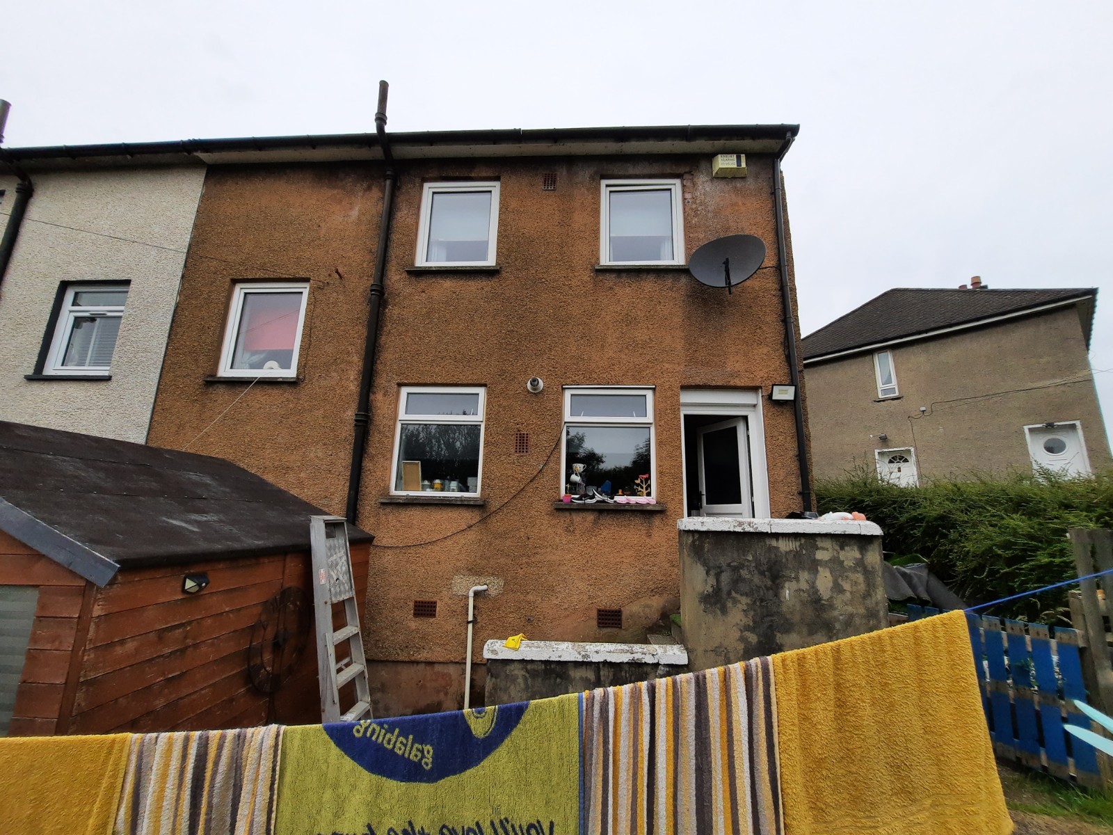 roughcast render Edinburgh on brown two-storey home