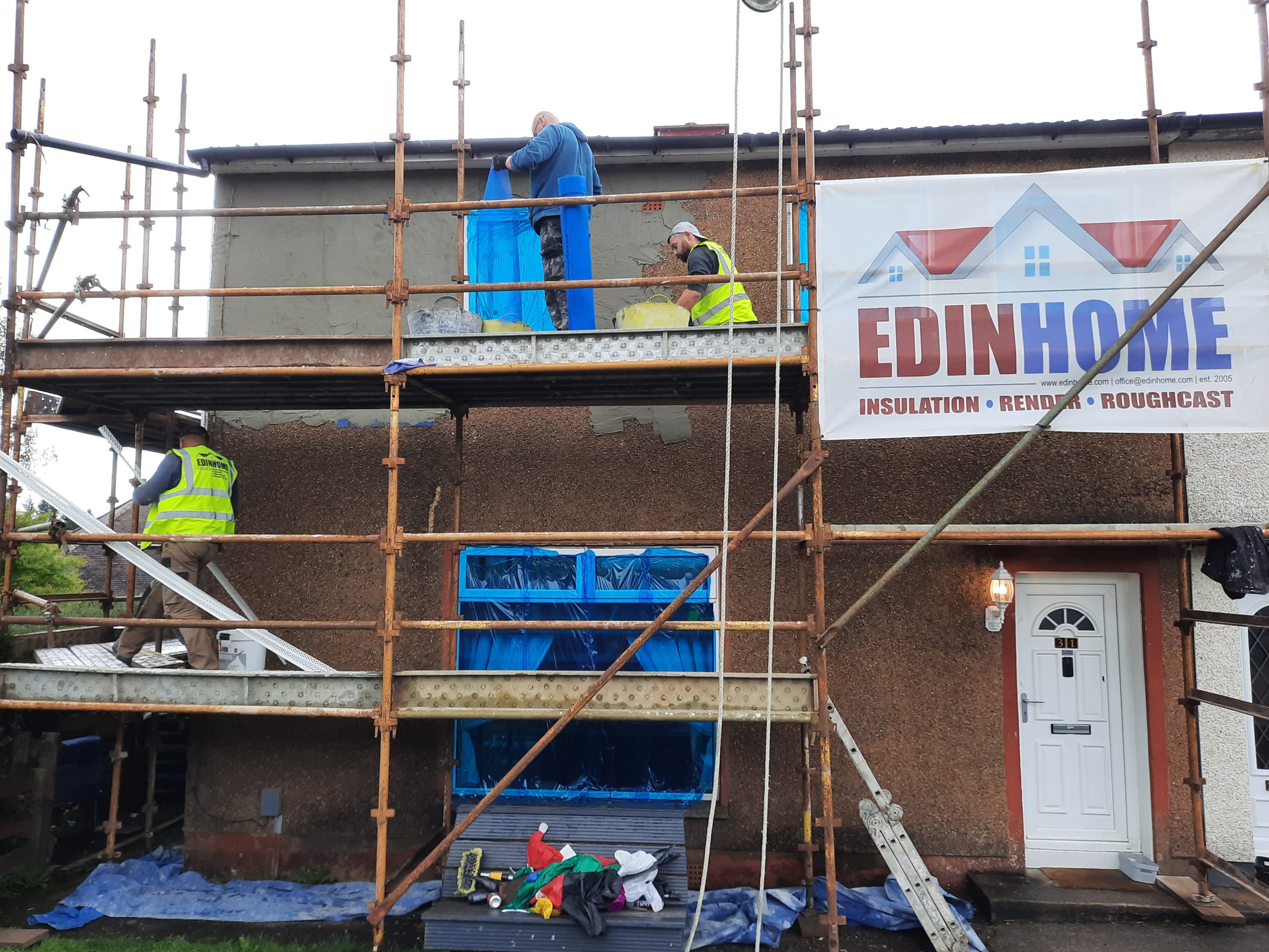 roughcasting Edinburgh on scaffolded brick house façade