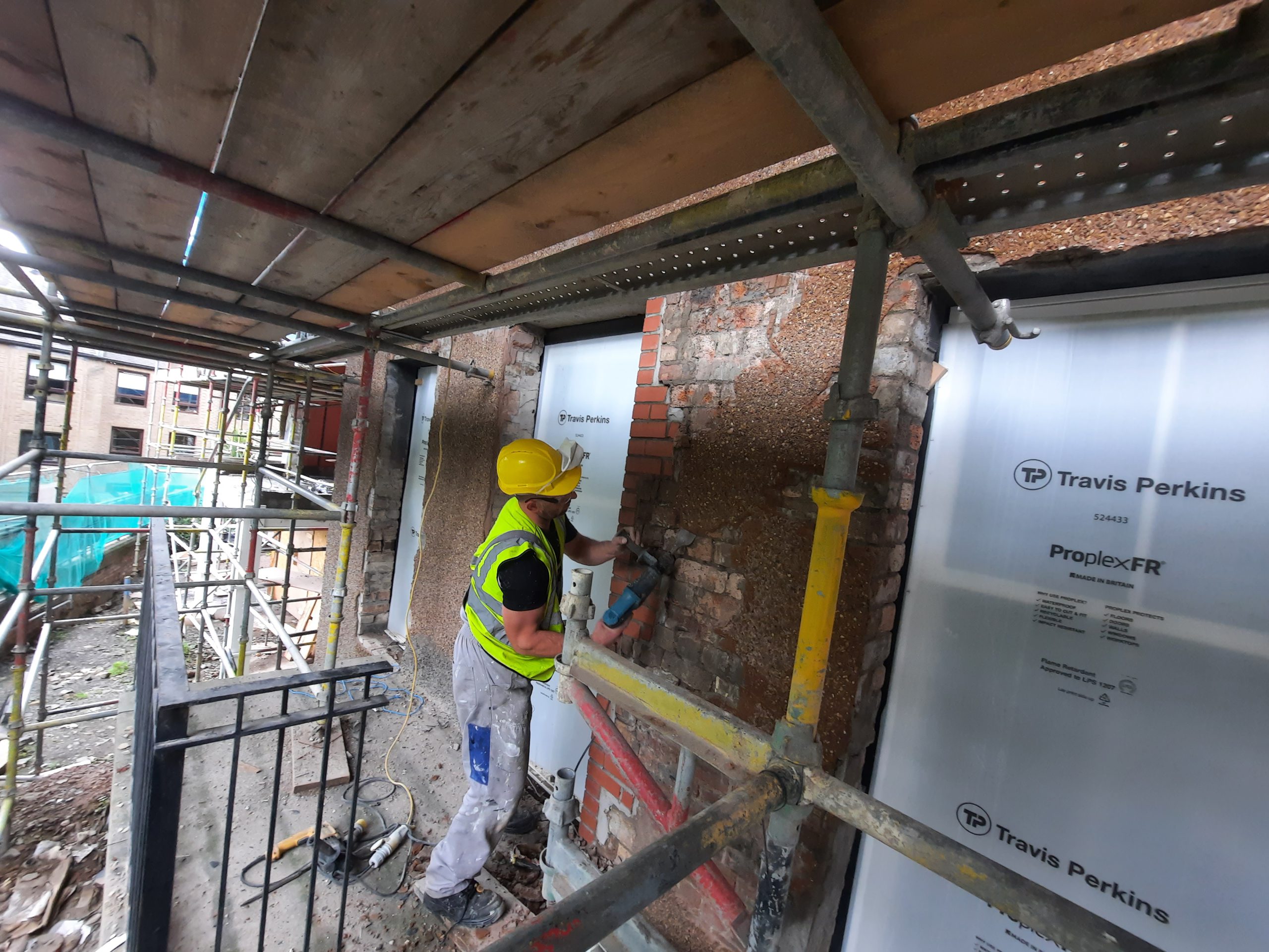 roughcaster Edinburgh installing insulation boards on exterior wall