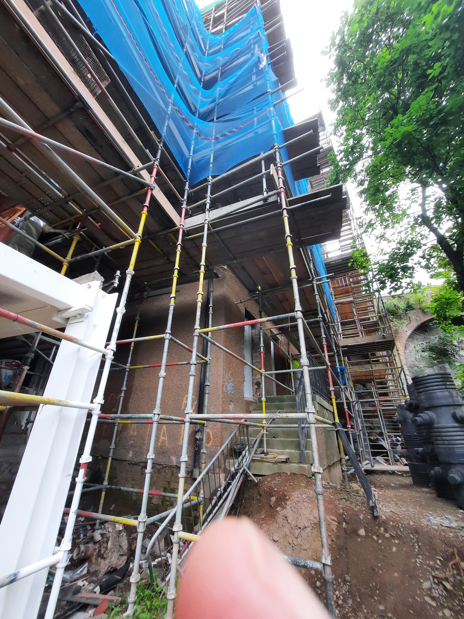 roughcast render Edinburgh building site with full scaffolding tower