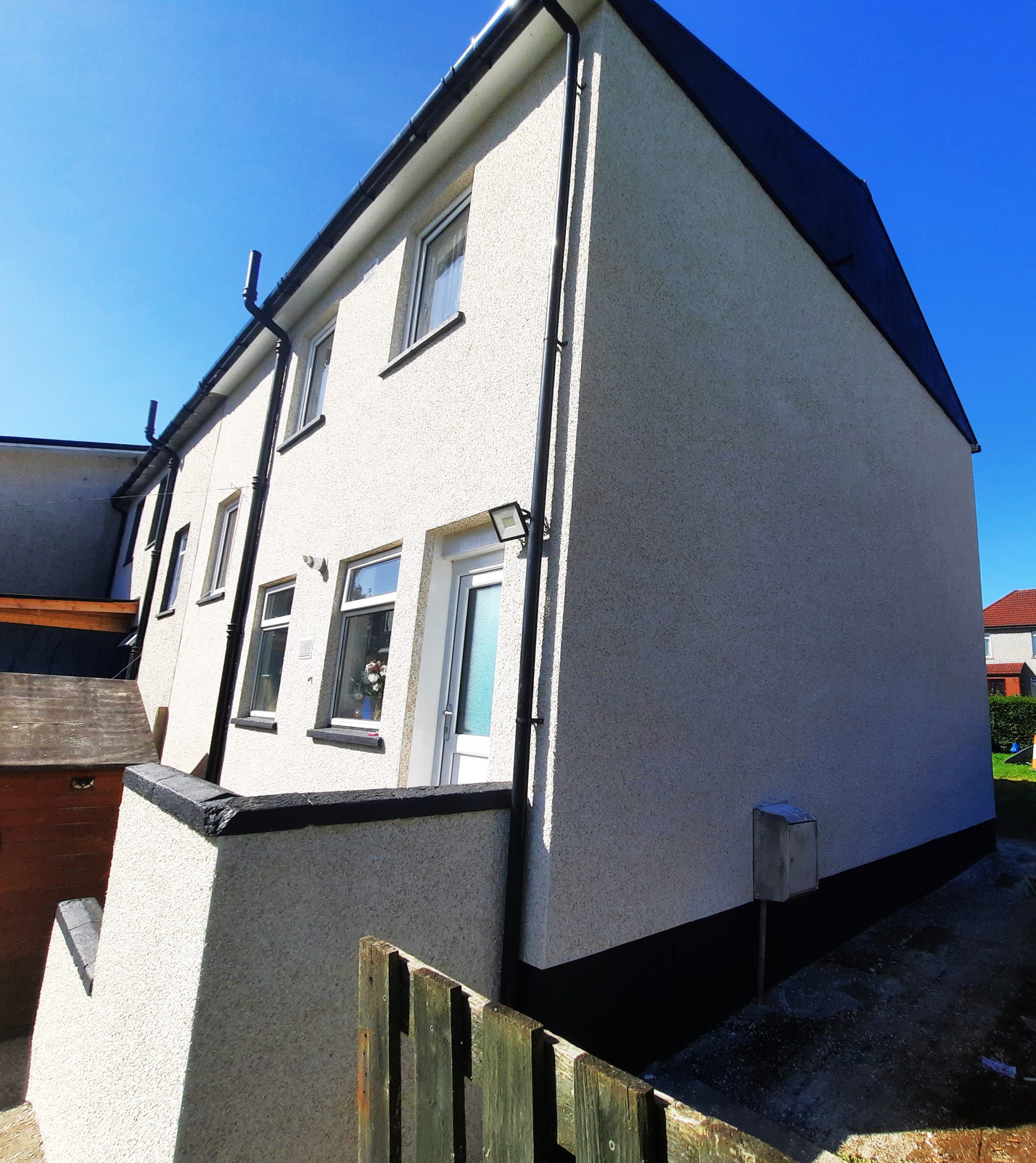 roughcast repair on tall narrow exterior wall