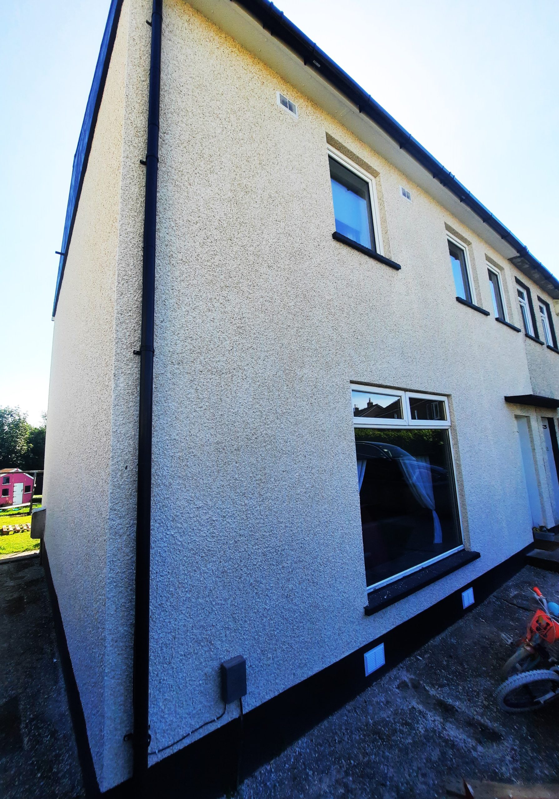roughcasting Edinburgh on bright white gable wall of semi-detached home