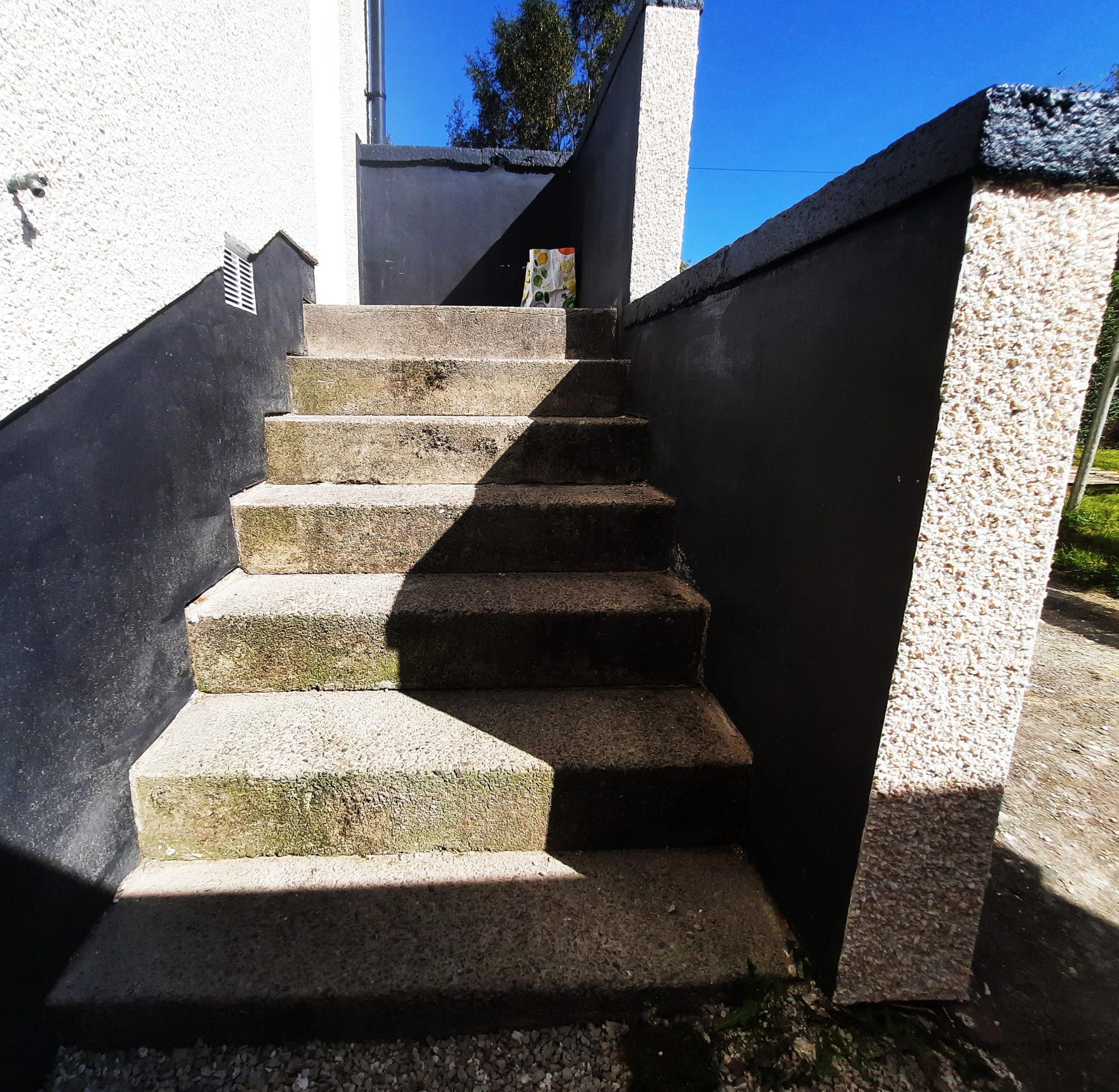 roughcast render repair on steps beside boundary wall