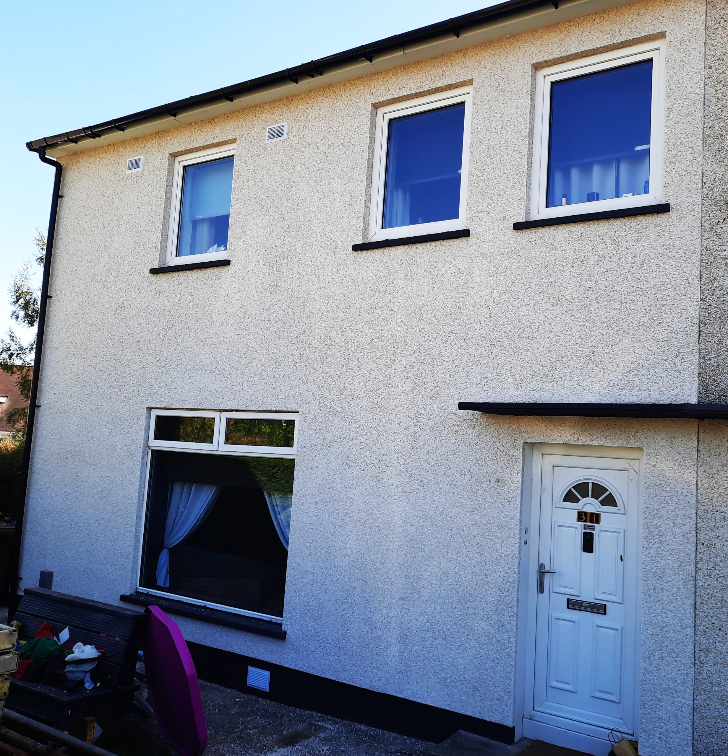 solid wall insulation Edinburgh on two-storey home with white walls