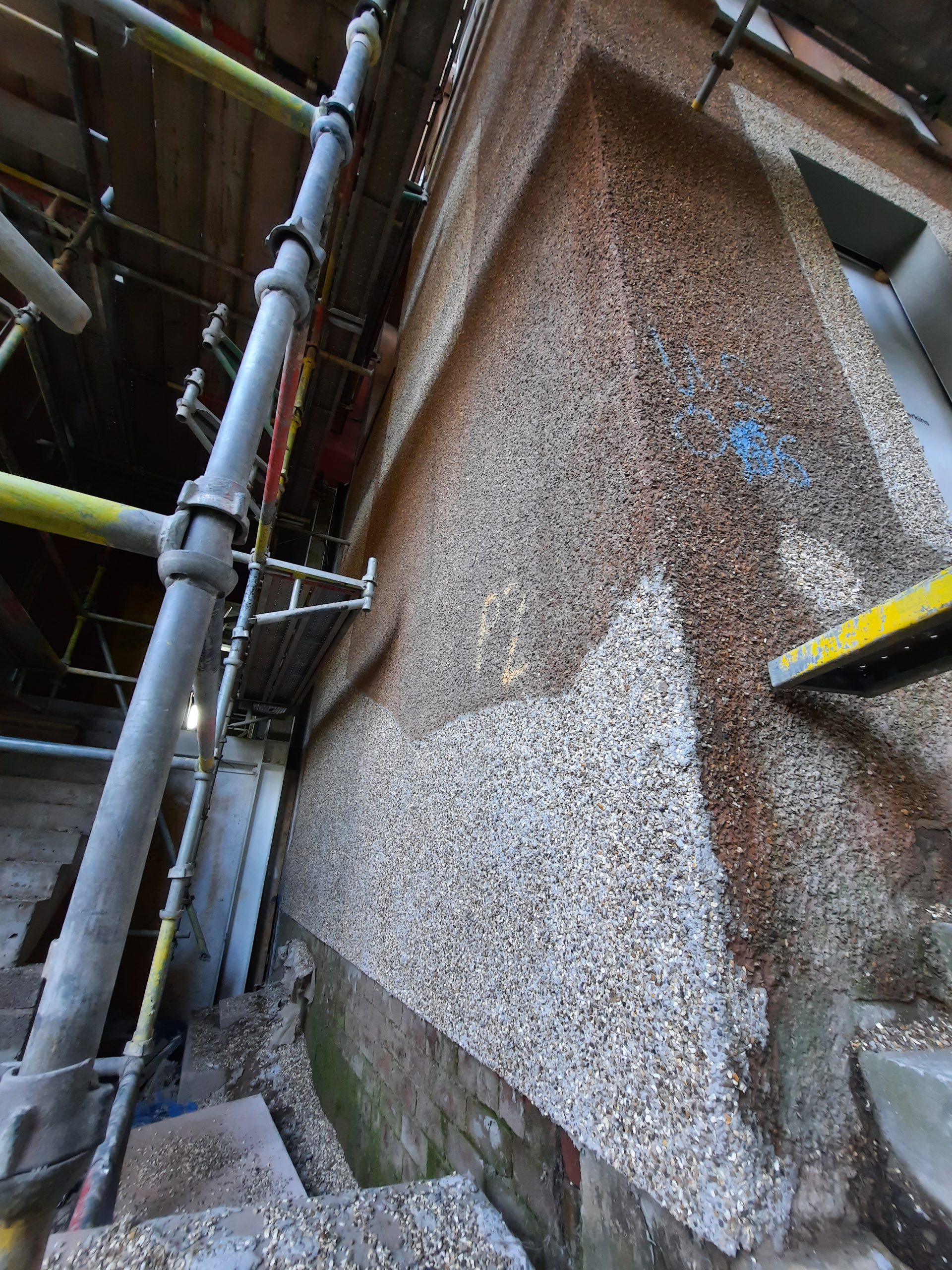 house rendering Edinburgh on wall section with old pebble dash