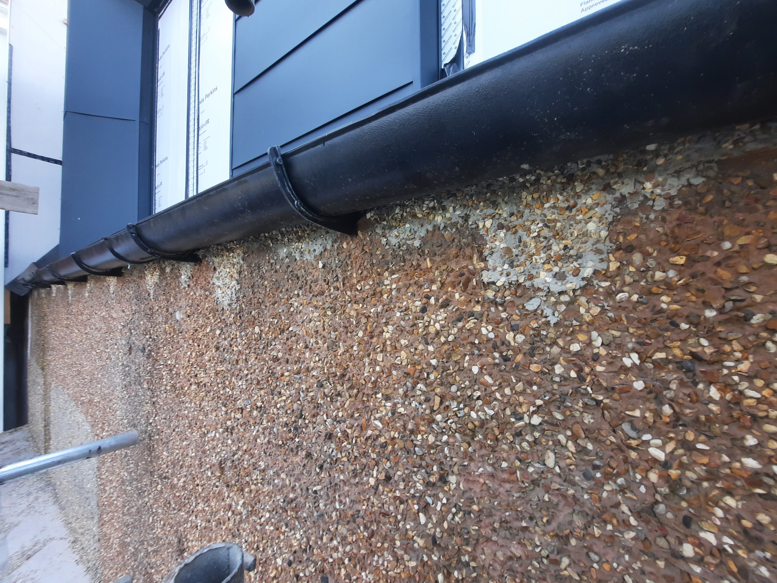 roughcast render Edinburgh close-up of worn pebble dash façade