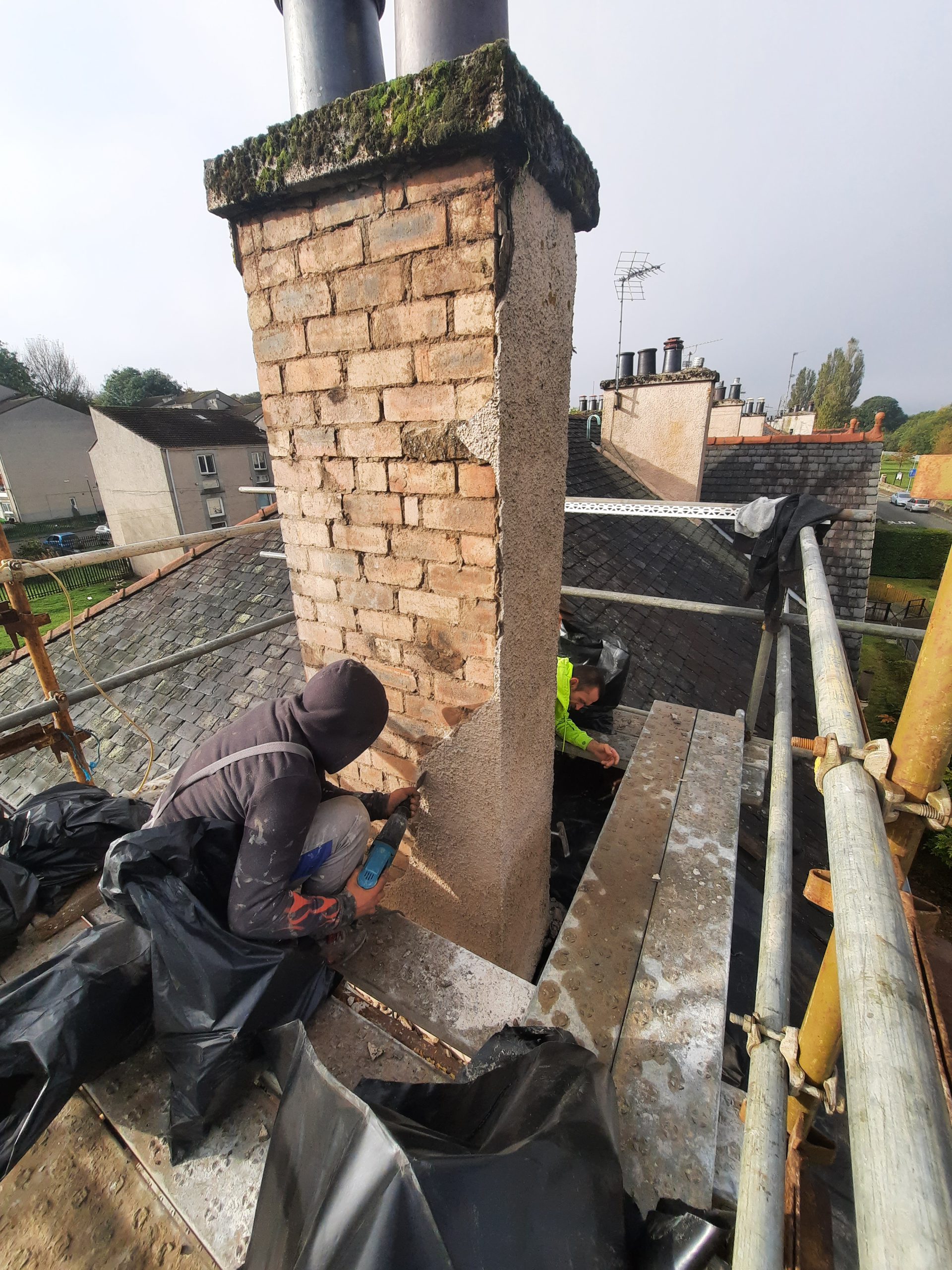 roughcast repair on weathered brick chimney stack