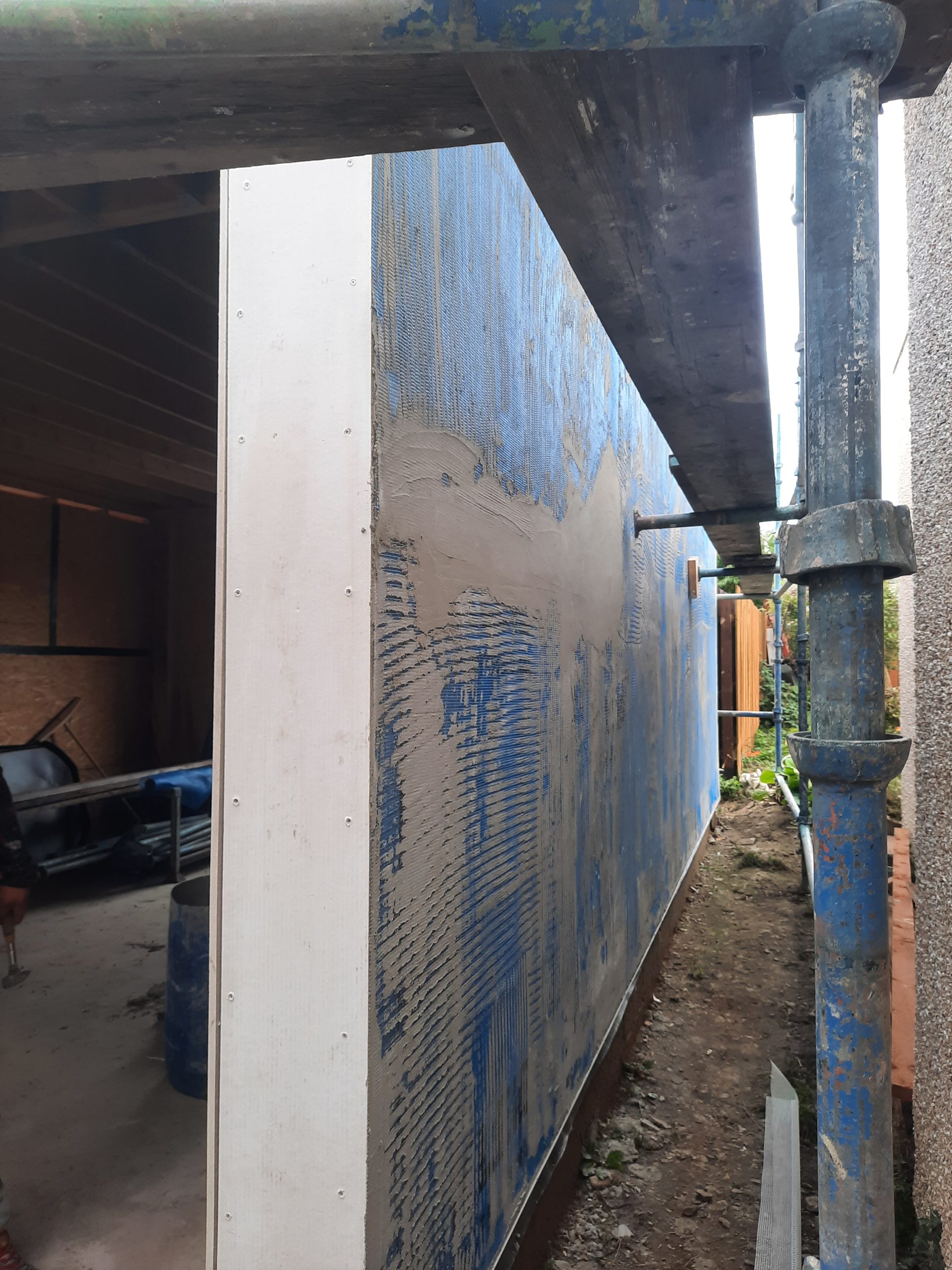 roughcast repair on side elevation with blue mesh visible