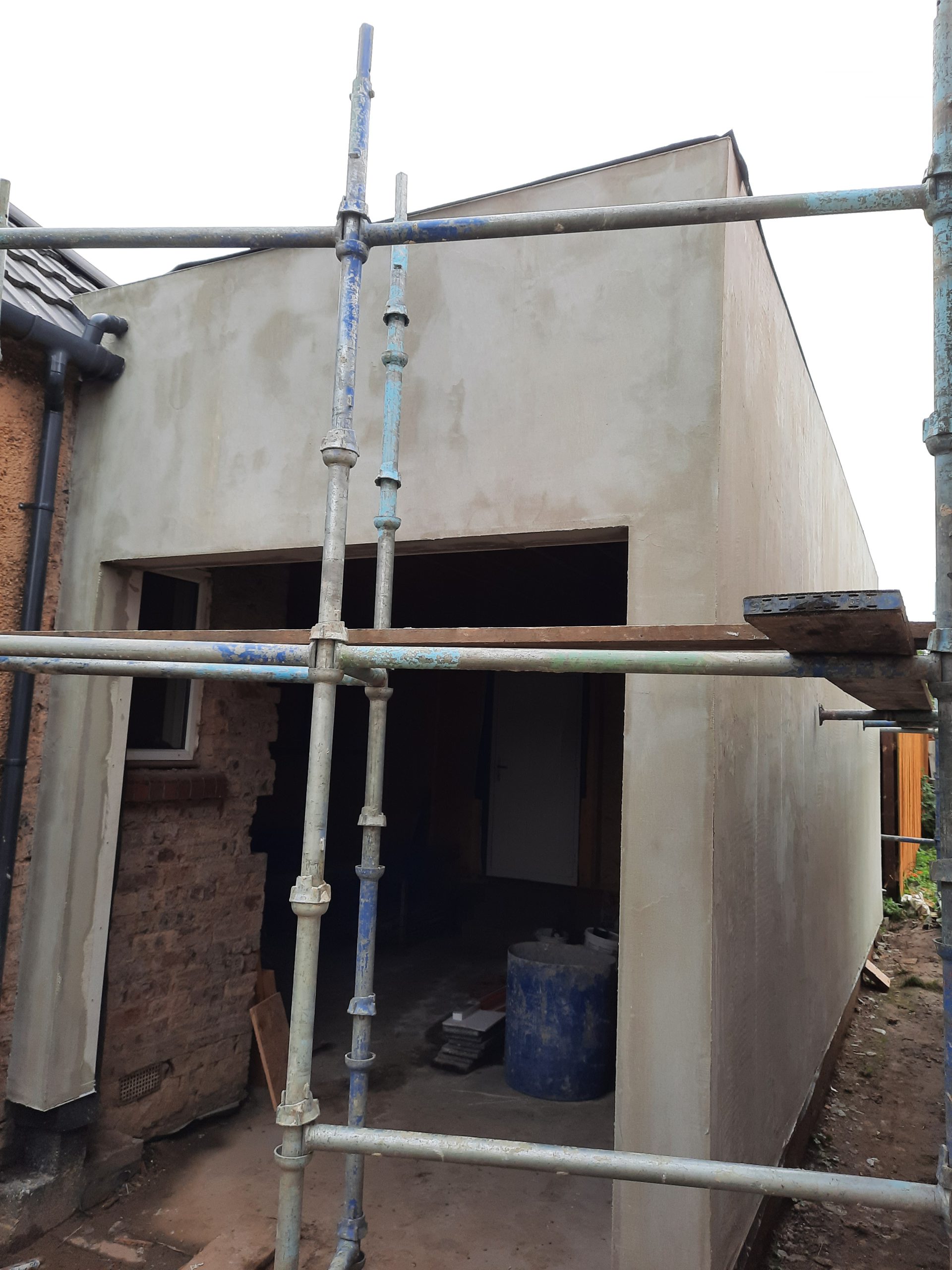 roughcast render repair at open entrance of new build