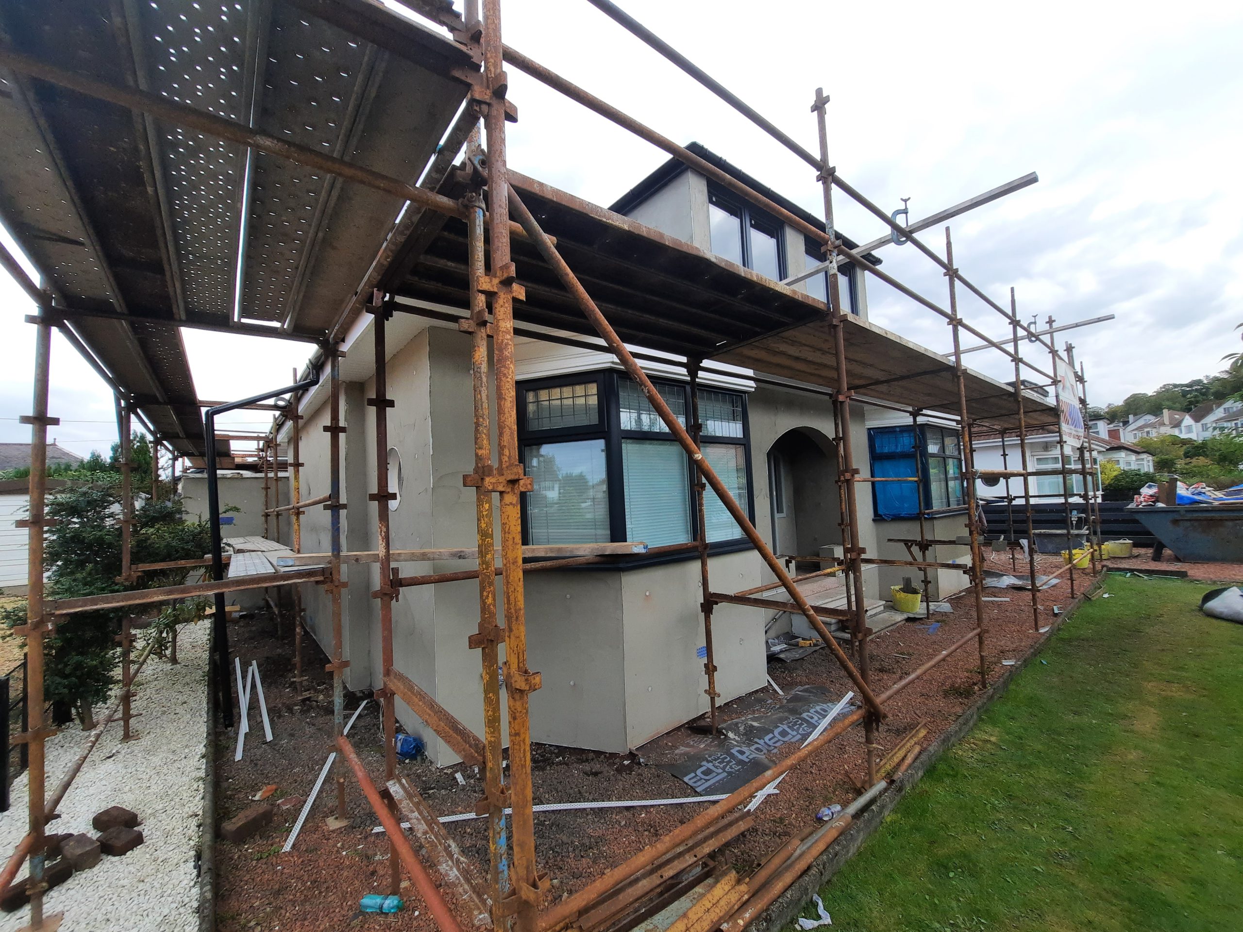 roughcast render repair in progress with scaffolding in place