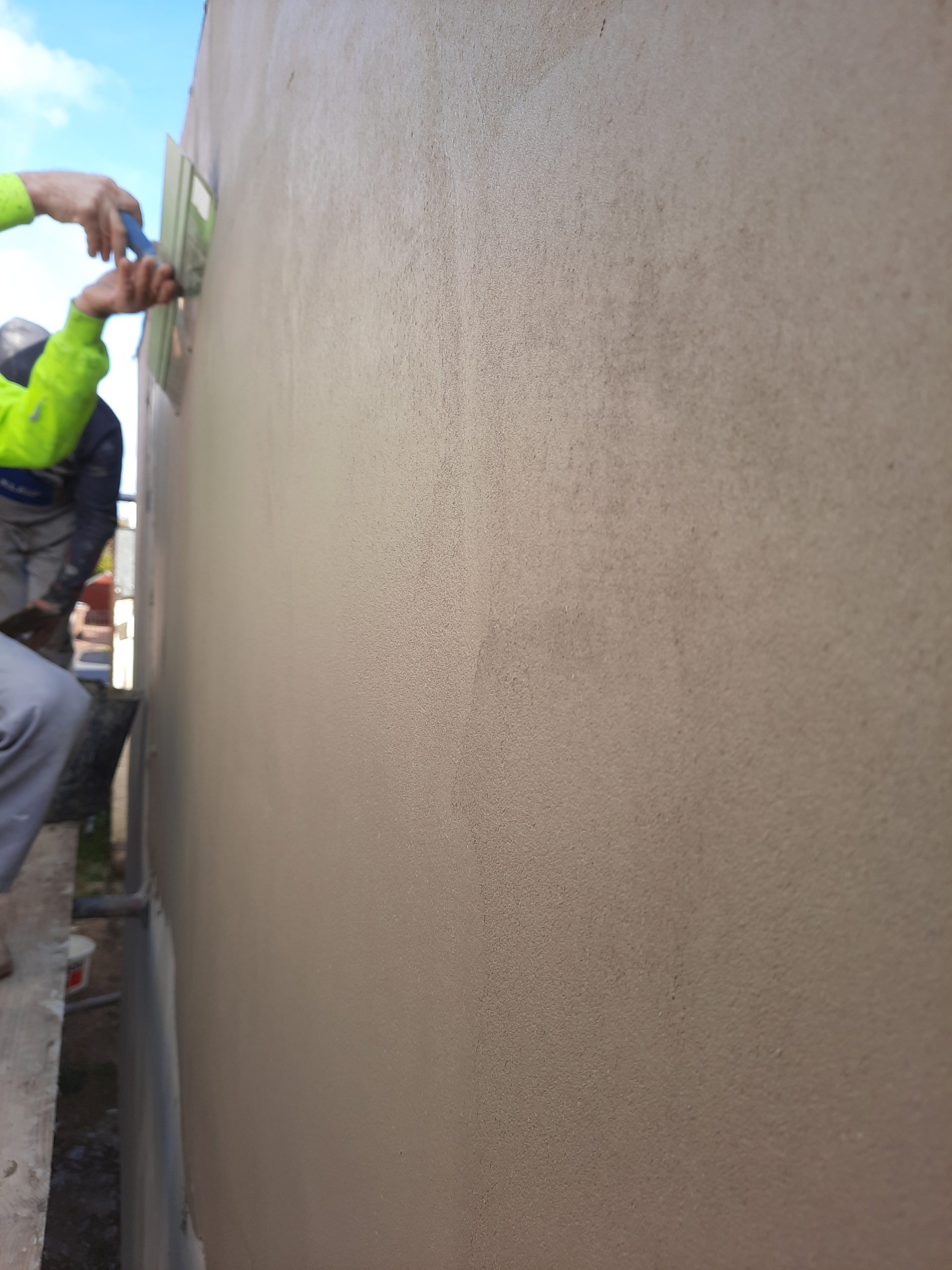 roughcast render repair on new-build wall surface