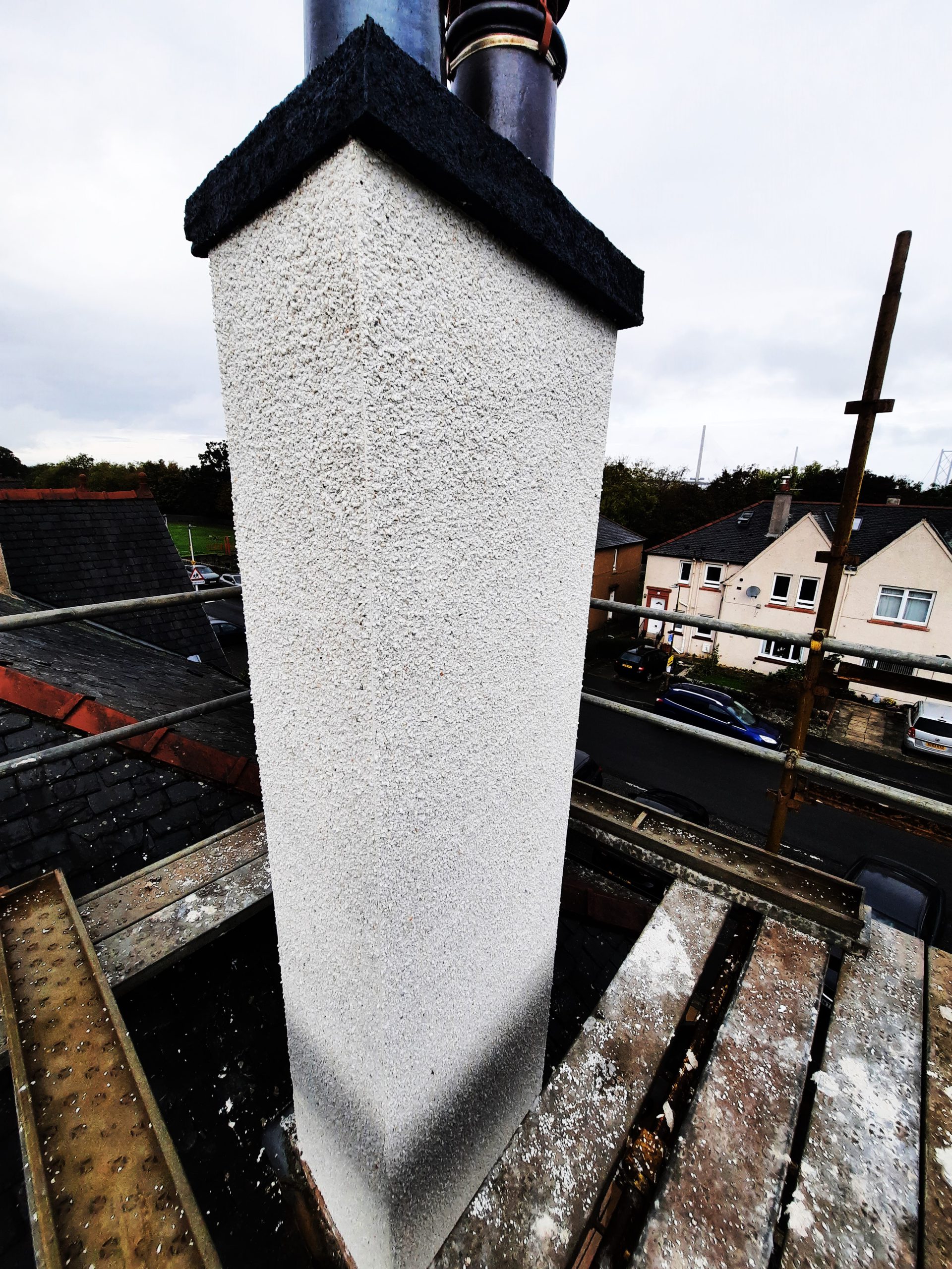 external wall insulation Edinburgh on tall white chimney