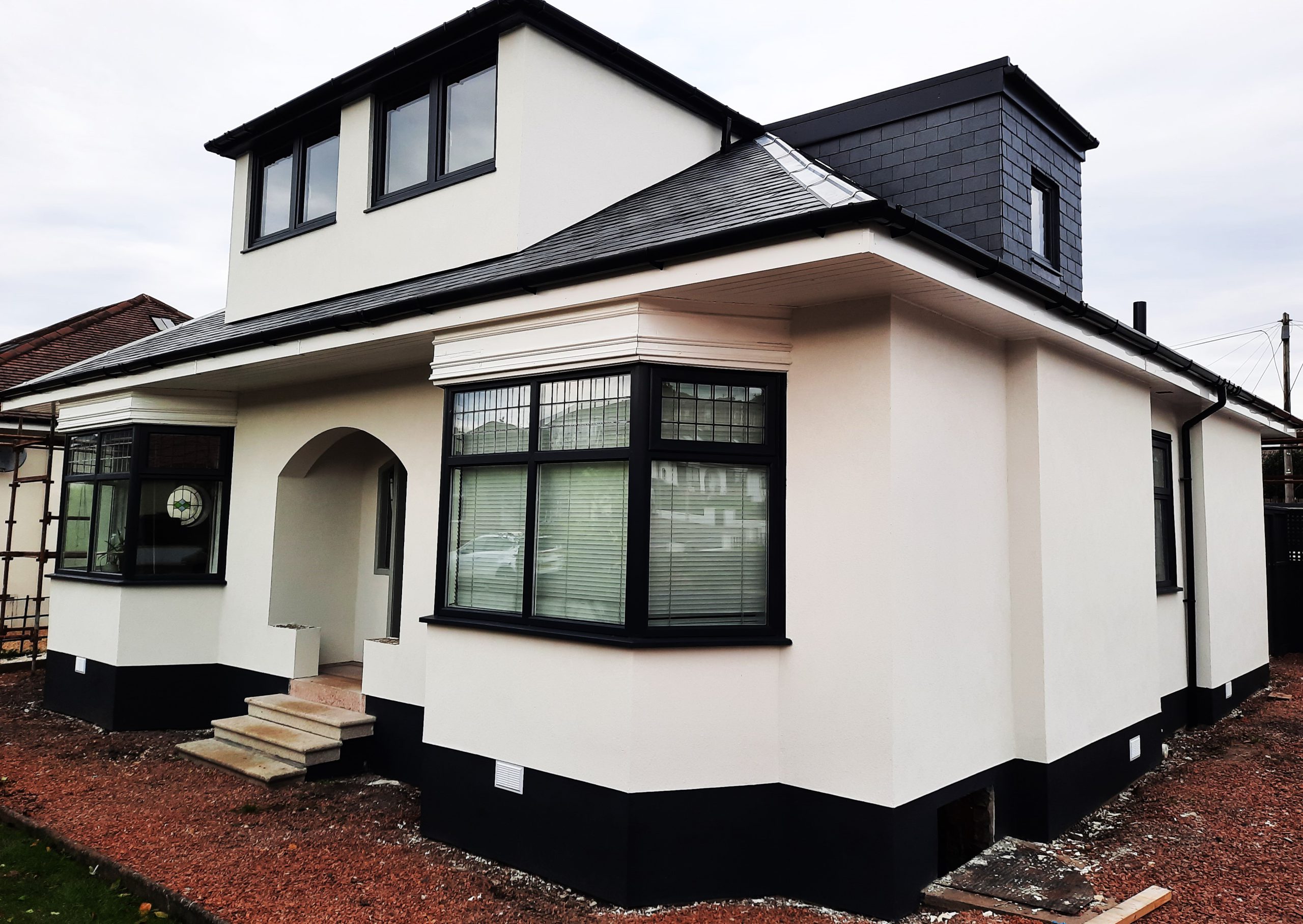 roughcast render repair on front façade with arched entrance