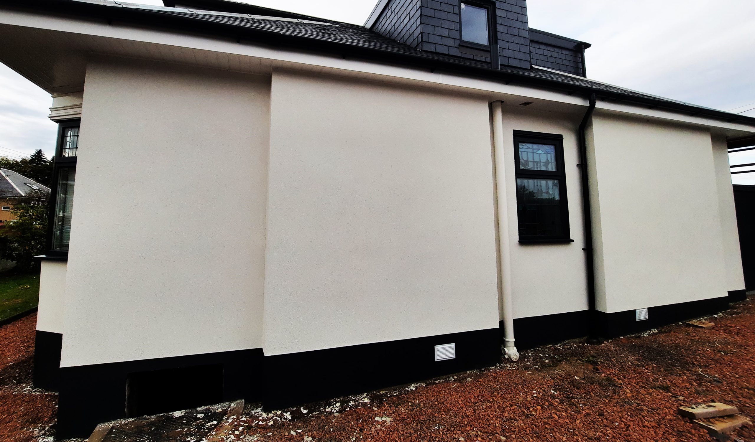 Insulation Edinburgh beneath smooth white render on side wall