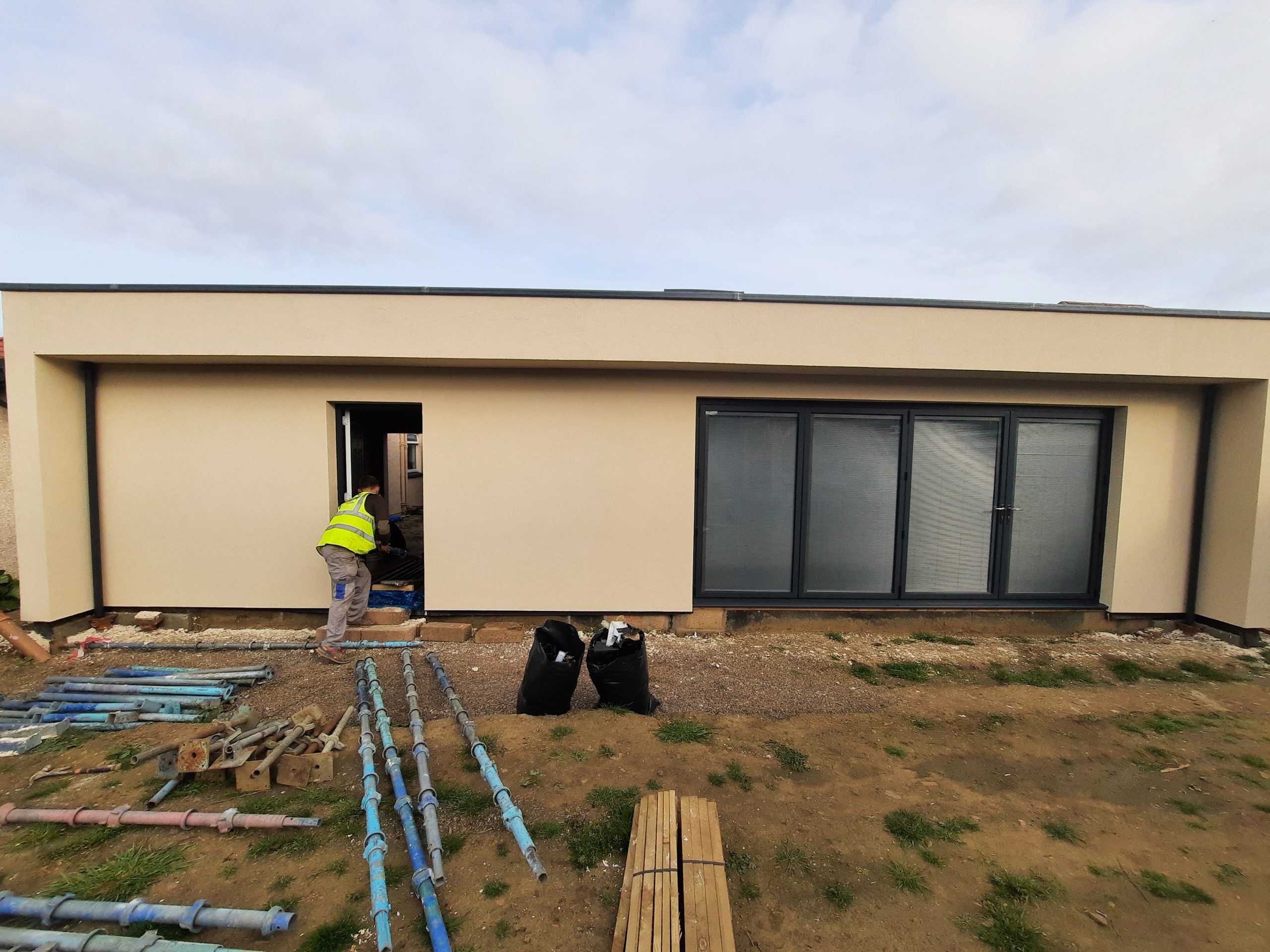 roughcasting Edinburgh on modern single-storey home with large windows
