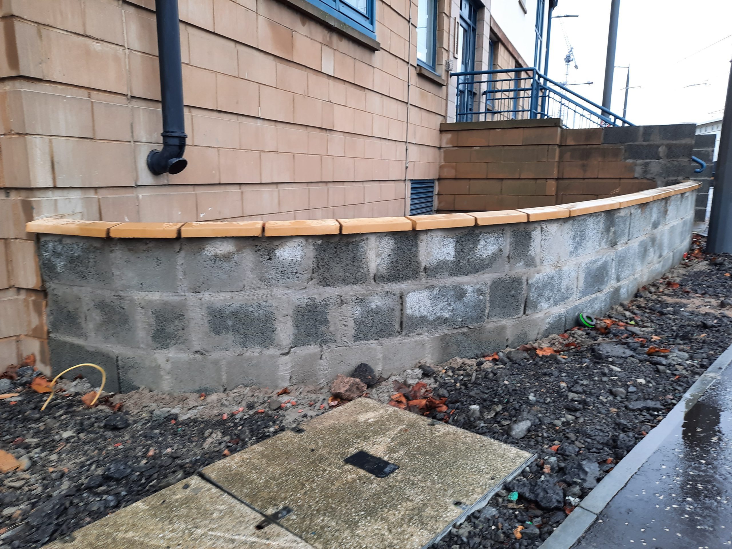 house rendering Edinburgh on wall beside blue metal staircase