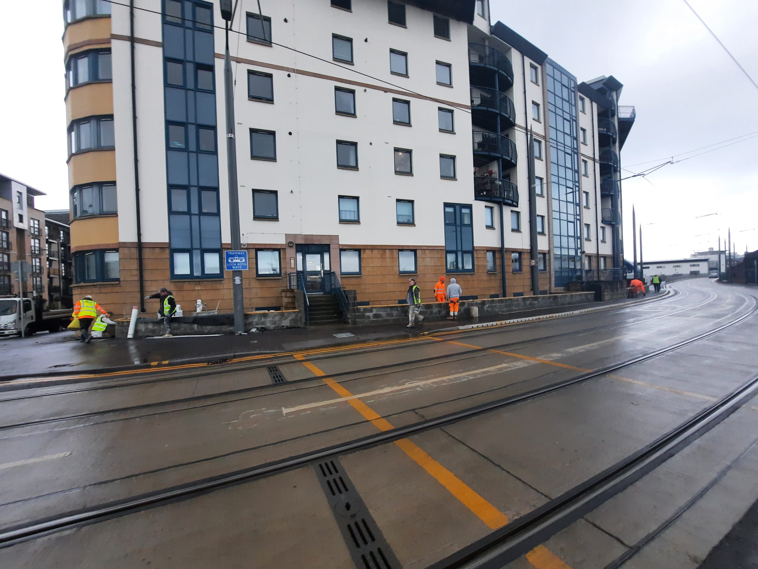 roughcast render repair team working on urban street project