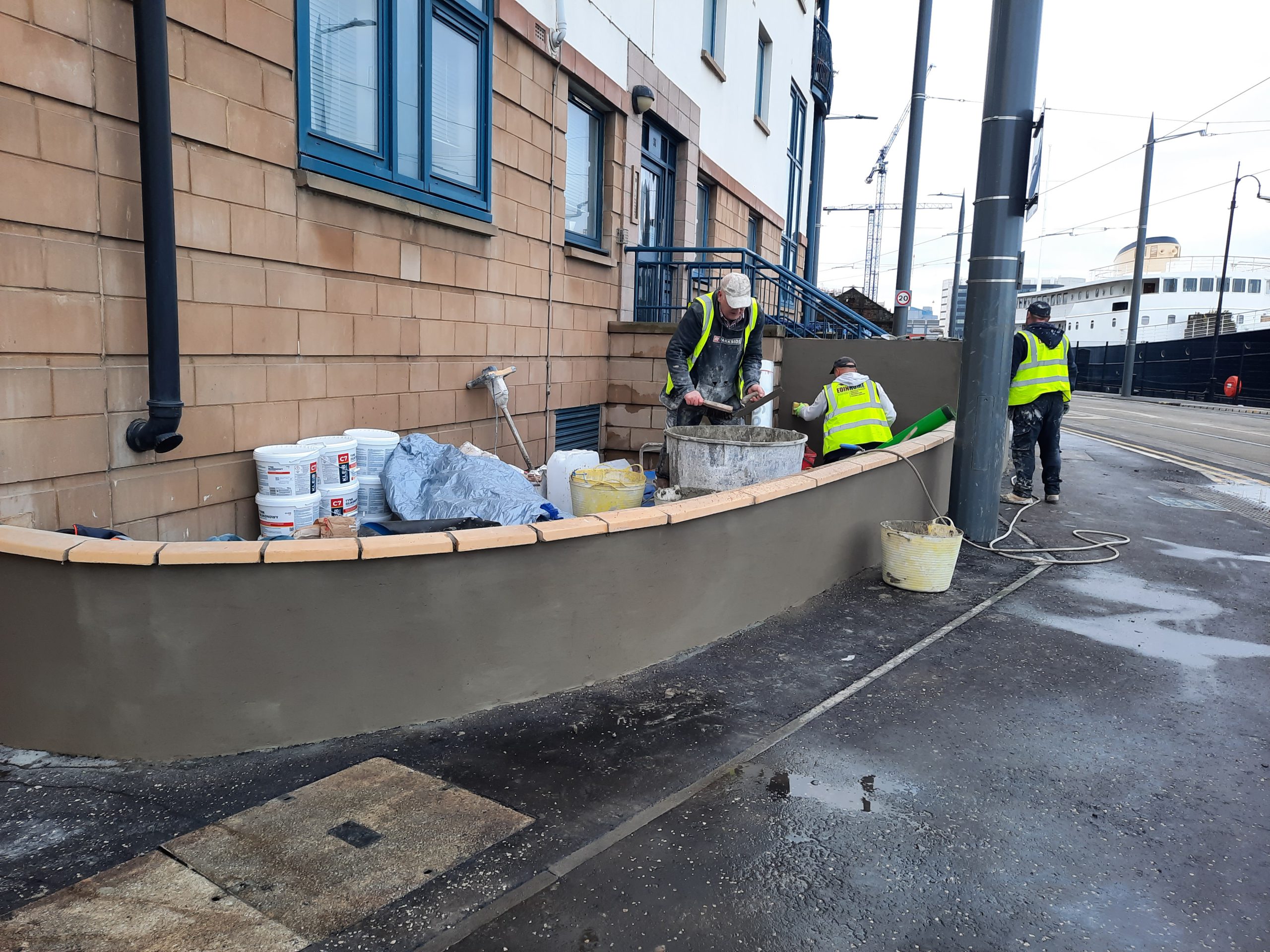 roughcast render Edinburgh work in progress on street-side wall