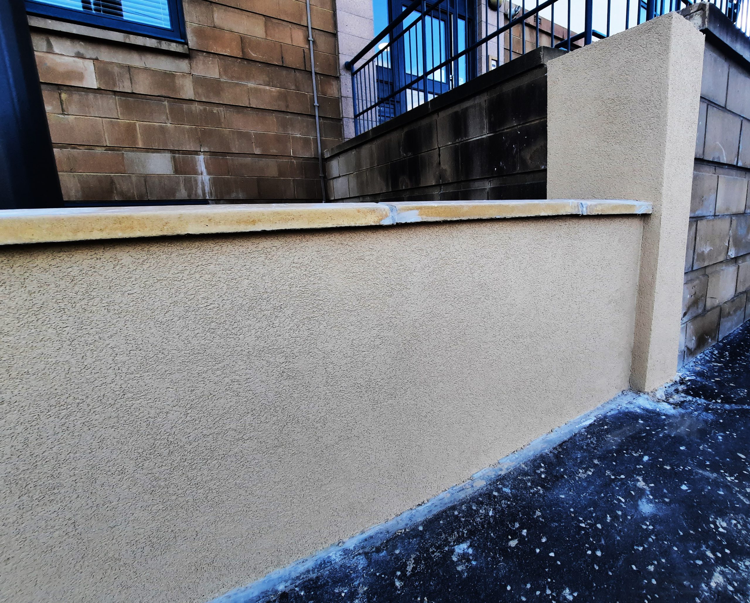Rendering Edinburgh on smooth beige perimeter wall