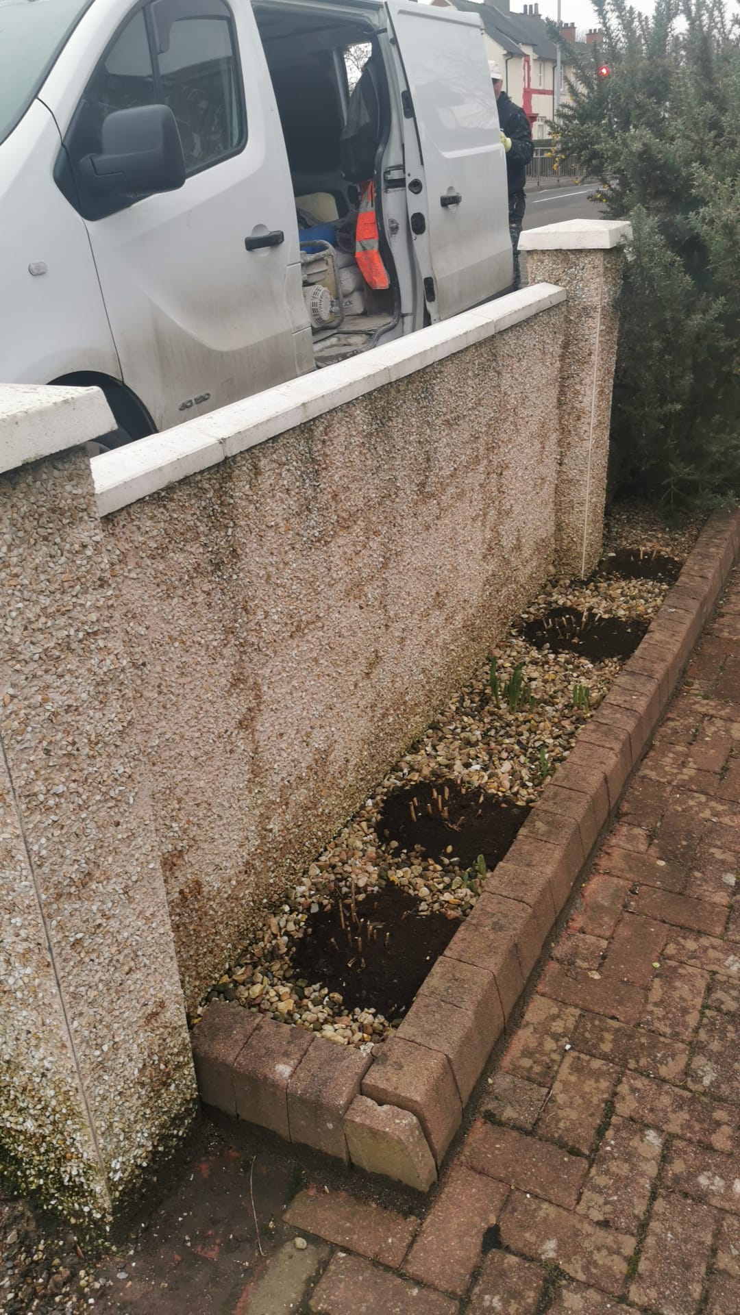 roughcast render repair on boundary wall returning to pebbledash finish