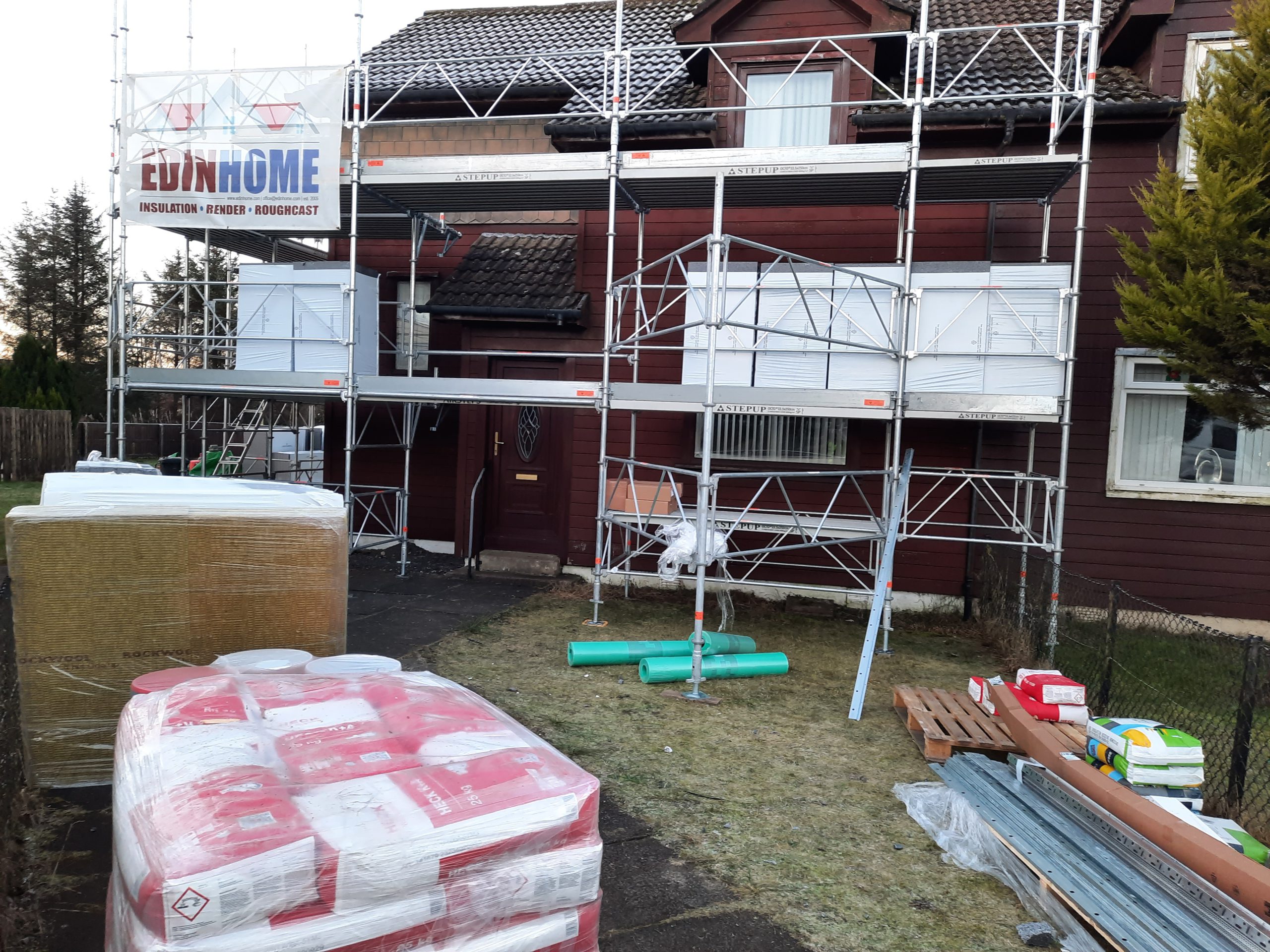 roughcast render repair project on scaffolded new-build façade