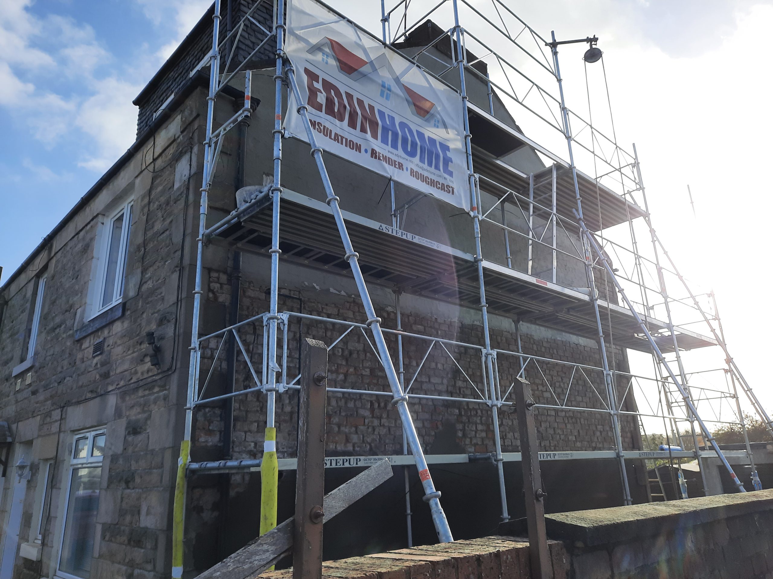 roughcaster Edinburgh restoring brick wall before rendering