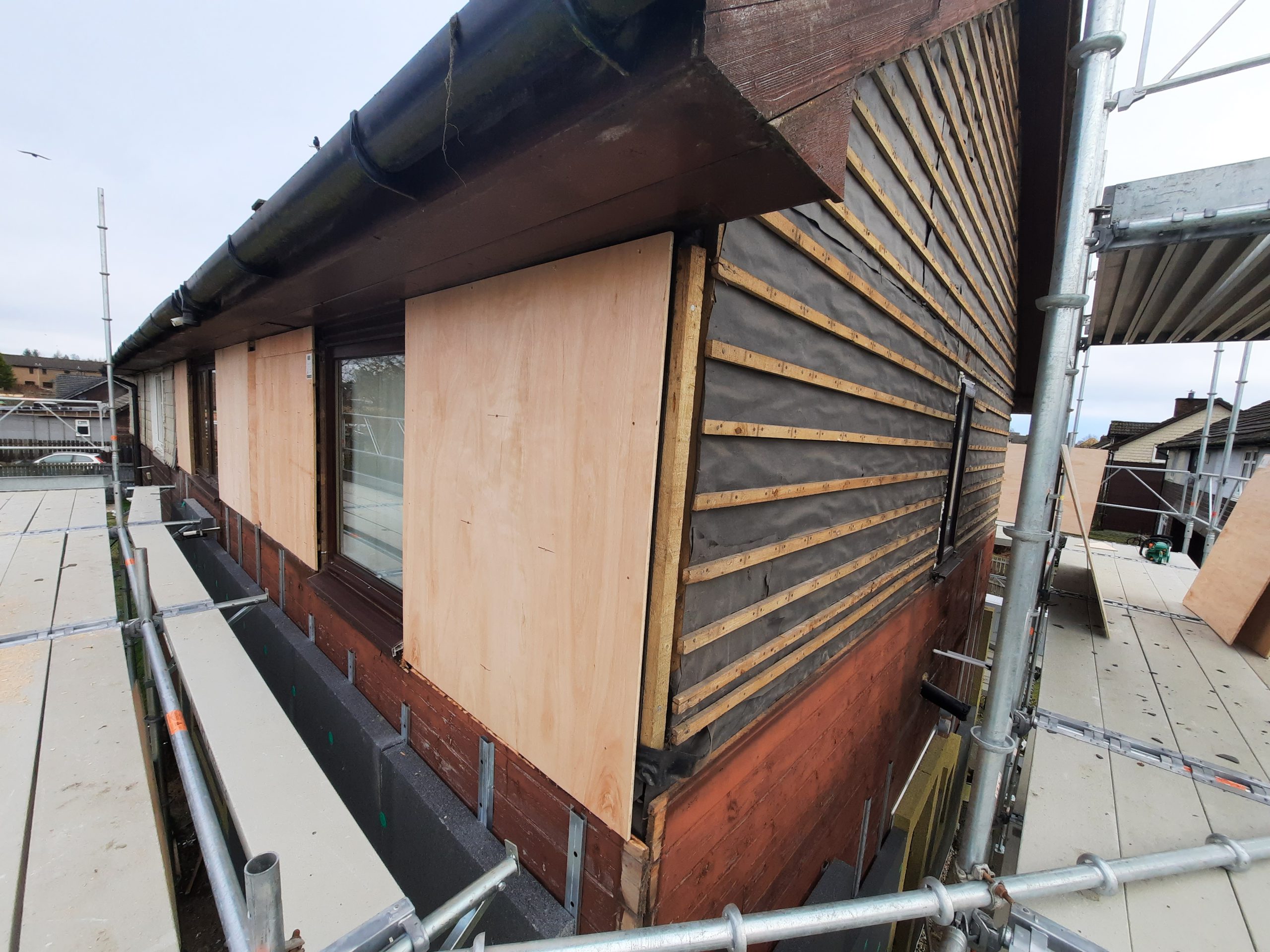 Insulation Edinburgh being installed behind timber cladding
