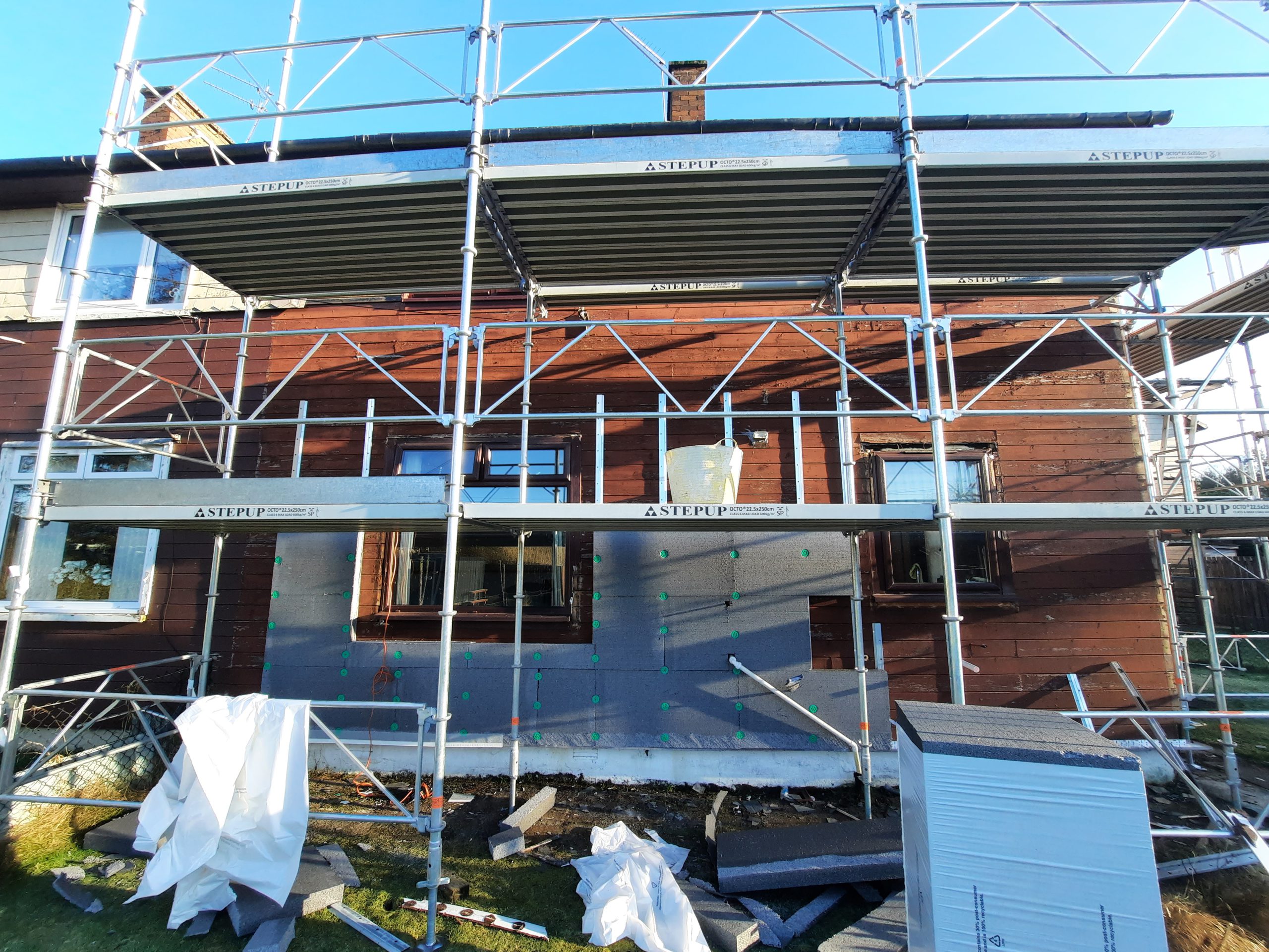 roughcast render repair on upper wall beside new roof