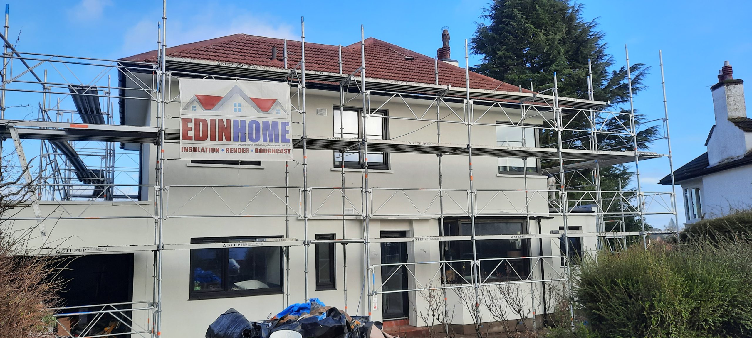 roughcast repair on sloped roof with moss buildup