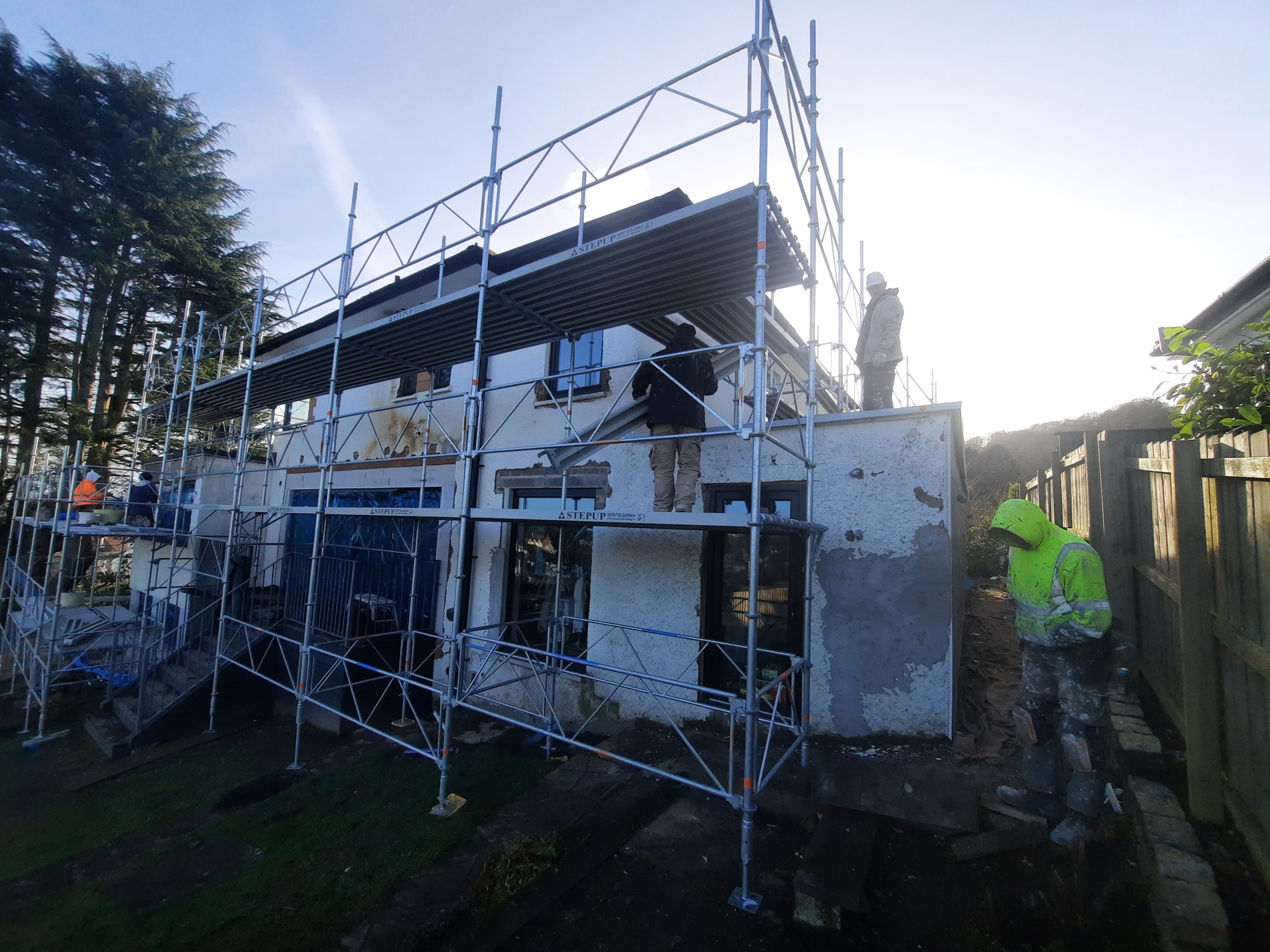 roughcast render repair in progress on back of property